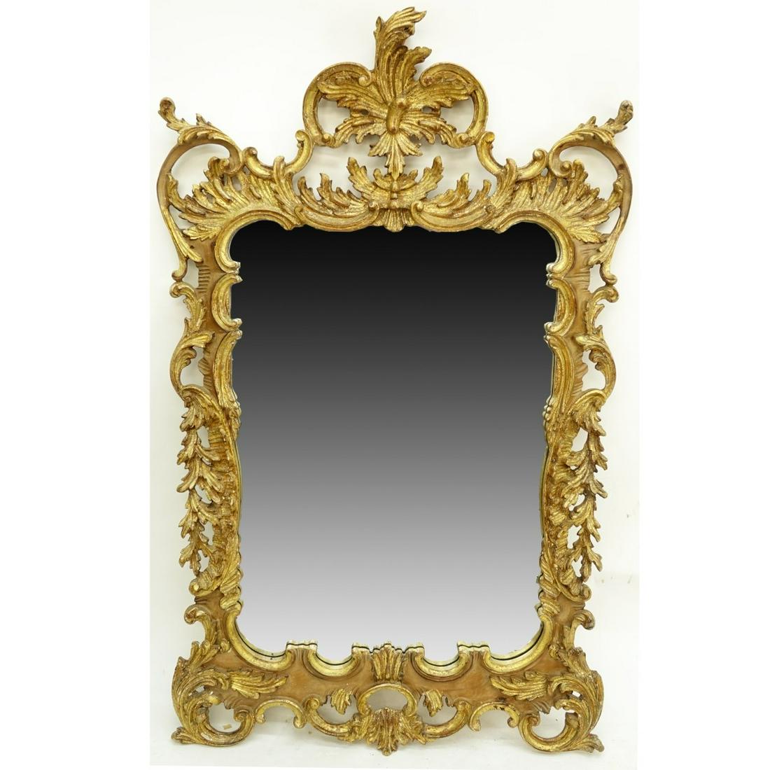 Louis XV Style Giltwood Mirror: Large Mid Century Louis XV Style Giltwood Mirror. Rococo form, foliage and openwork motif. Measures 57" H x 35-1/2" W. Condition: Normal rubbing overall good condition Estimate: $100.00 - $300.00 Dome