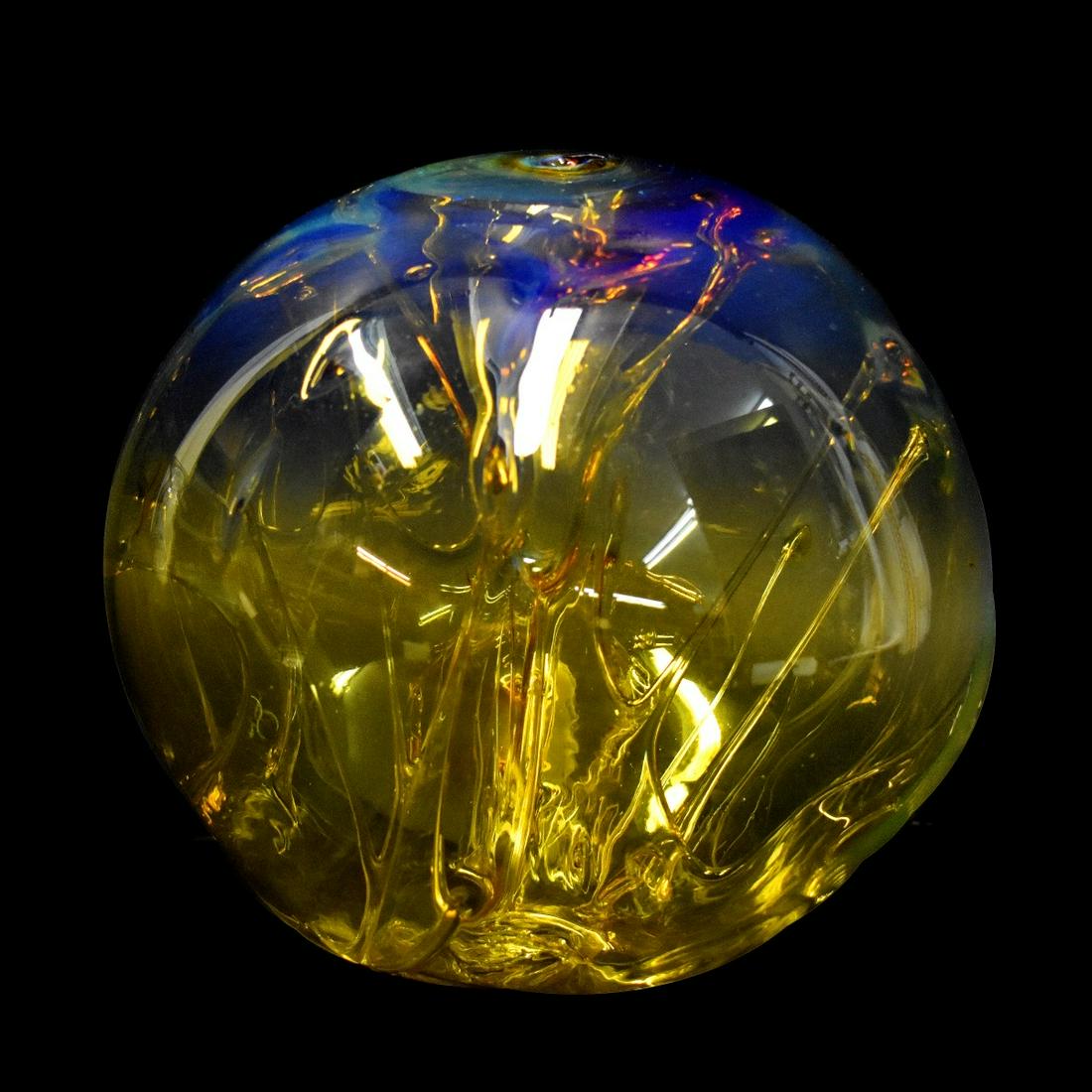 Peter Bramhall, American (Born 1942): Peter Bramhall, American (Born 1942) Large Amber to Clear Art Glass Orb Sculpture. Signed and dated 10/1/81 on the bottom side. Open pontil base. Measures 9-1/2" H x 9-1/2" W. Condition: Good conditio