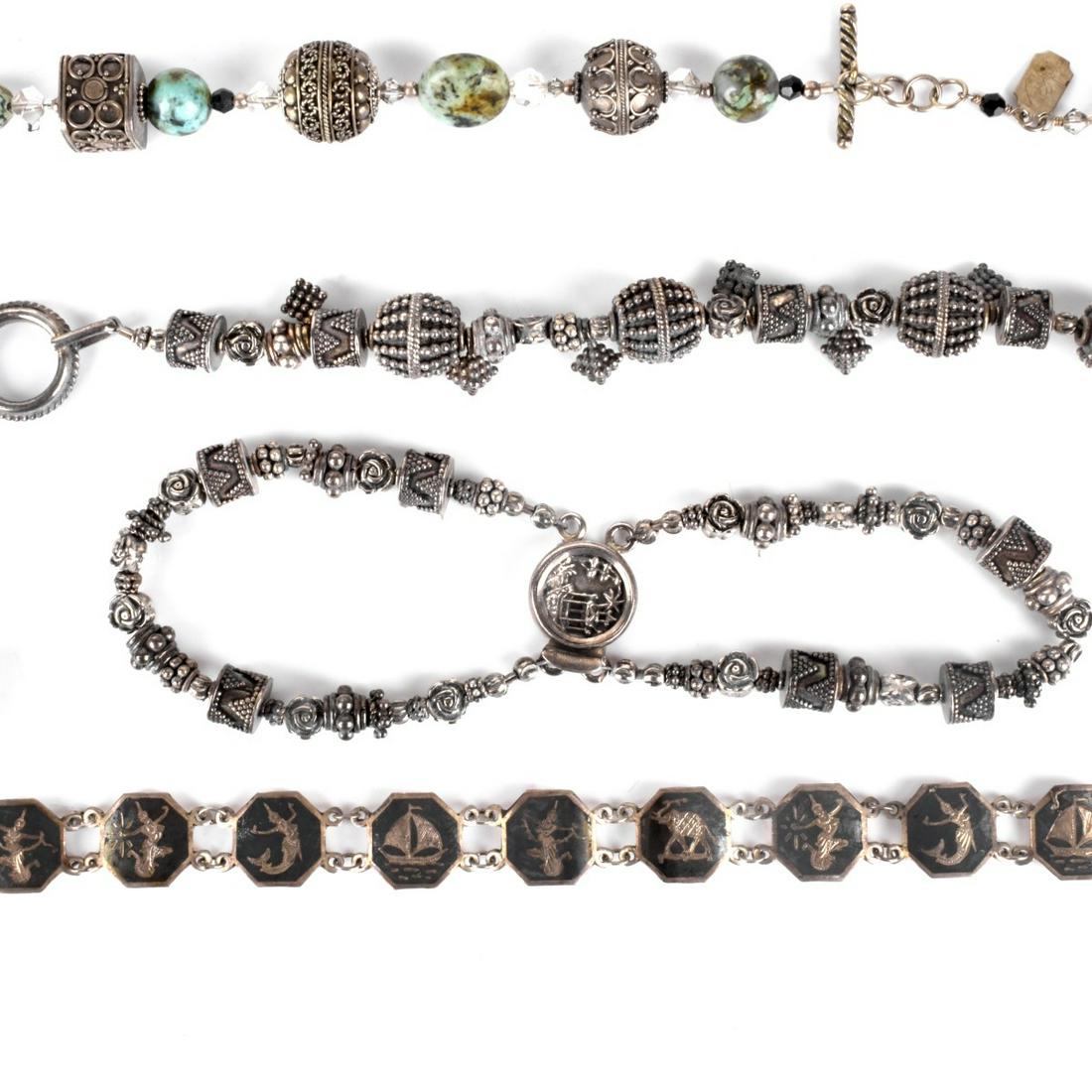 Six Silver Bracelets: Collection of Six Silver Bracelets Including Links London Sterling Stretch Bracelet, Two Siam Sterling Link Bracelets, Double Strand Sterling Bead Bracelet, Bead Bracelet not marked, Tres Jolie Bead B