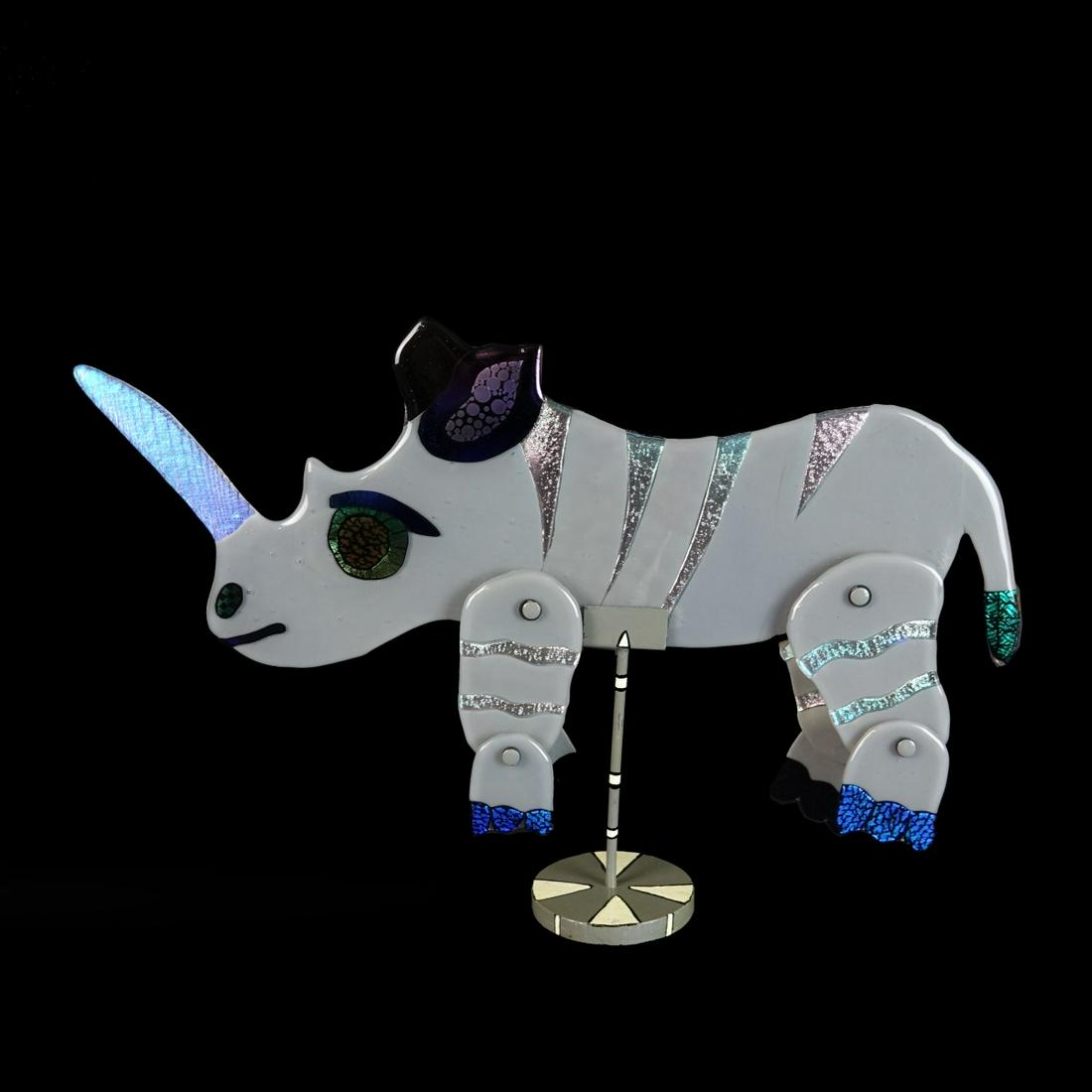 Modern Art Glass Rhino Sculpture: Mid Century Modern Art Glass Kinetic Rhino Sculpture Presented on a Metal Base. Unsigned. Sculpture measures 12-1/2" x 22". Condition: Good condition Estimate: $100.00 - $300.00 Domestic Shipping: Thi