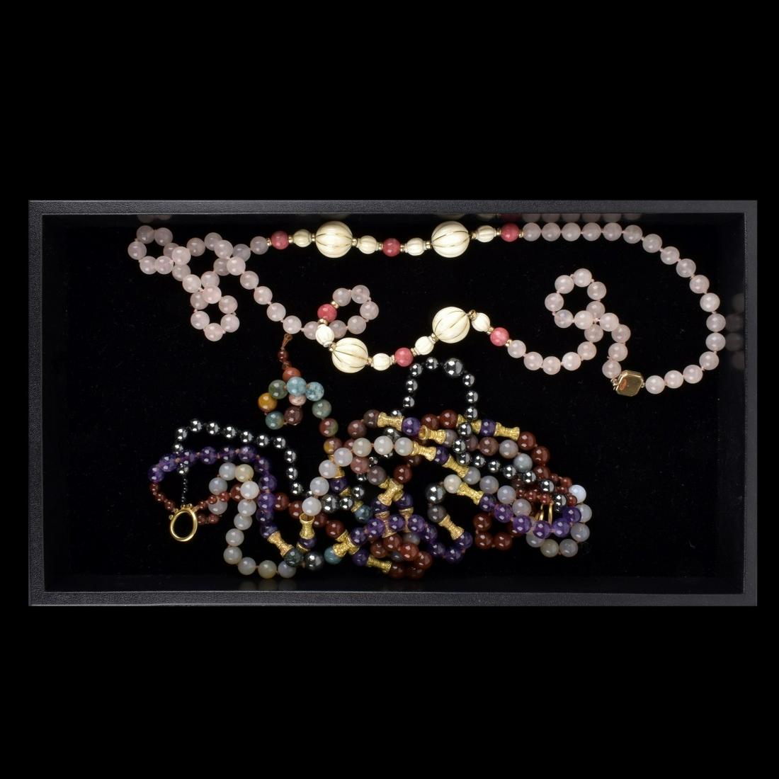 Two (2) Vintage Gemstone Beaded Necklaces: Grouping of Two (2) Vintage Gemstone Beaded Necklaces. Unmarked. Chinese influence. Single string: Rose quartz and carved bone. Multi string: Amethyst, Carnelian, hematite and Agate. Condition: Multi