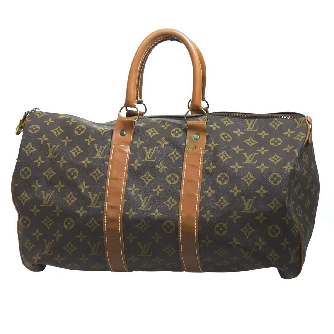 Faux Louis Vuitton Monogram Vinyl Luggage Handbag: Faux Louis Vuitton Monogram Vinyl Luggage Handbag. Label on interior marked Louis Vuitton manufactured in the USA under special license to the French co. Gold tone hardware, single interior compartmen
