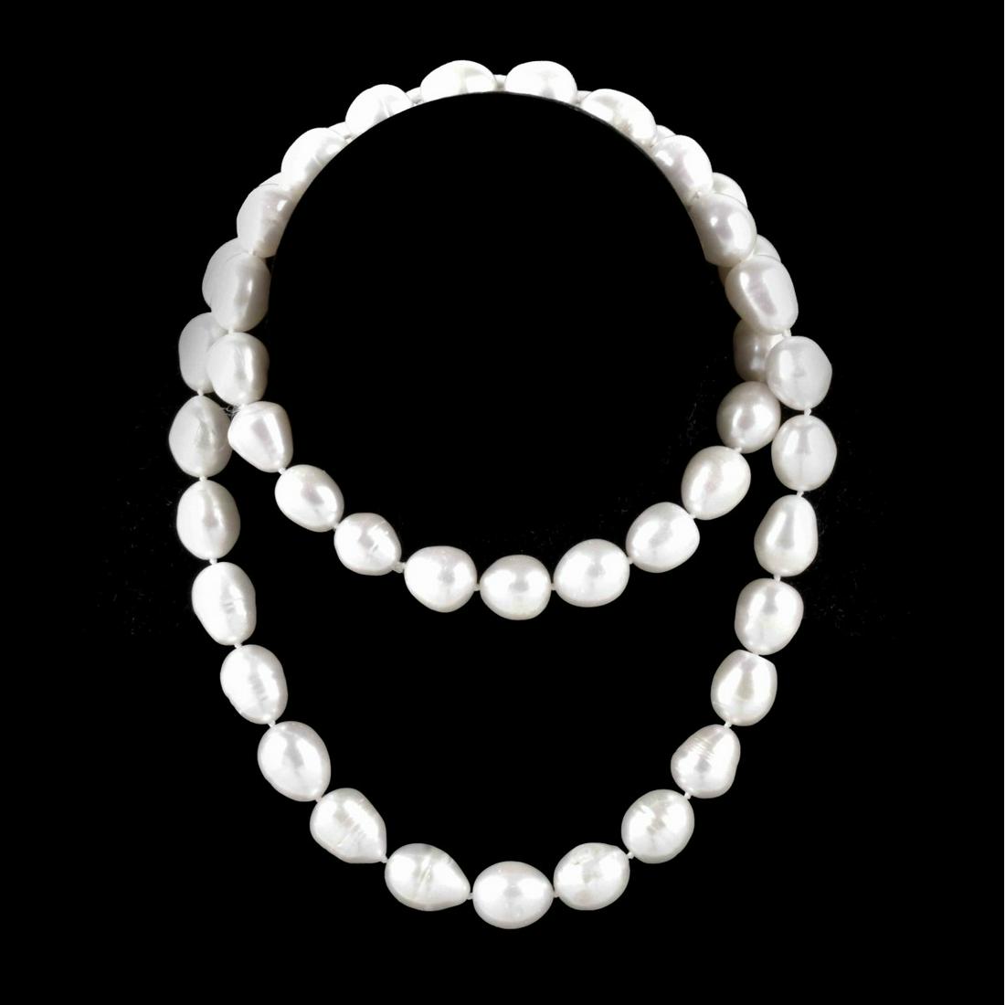 Baroque Pearl Necklace: Single Strand Forty Eight Large Baroque Pearl Necklace. Pearls with good polish and luster measure approx. 11.0-12.0mm. Minor natural blemishes. Necklace measures 27" L. Approx. weight; 126.08 grams. 