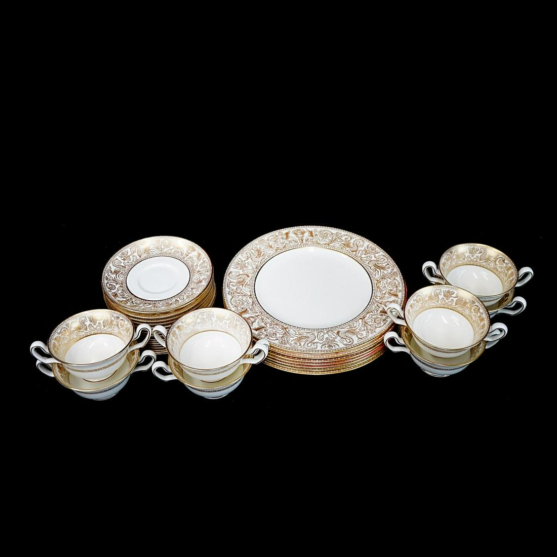 (31) Pc. Wedgwood "Florentine Gold" Dinnerware: Thirty One (31) Pc. Wedgwood "Florentine Gold" Porcelain Dinnerware. Signed. Includes (7) plates measuring 10-3/4", (8) bread and butter plates measuring 6", (8) cream soup bowls, and (8) cream soup s