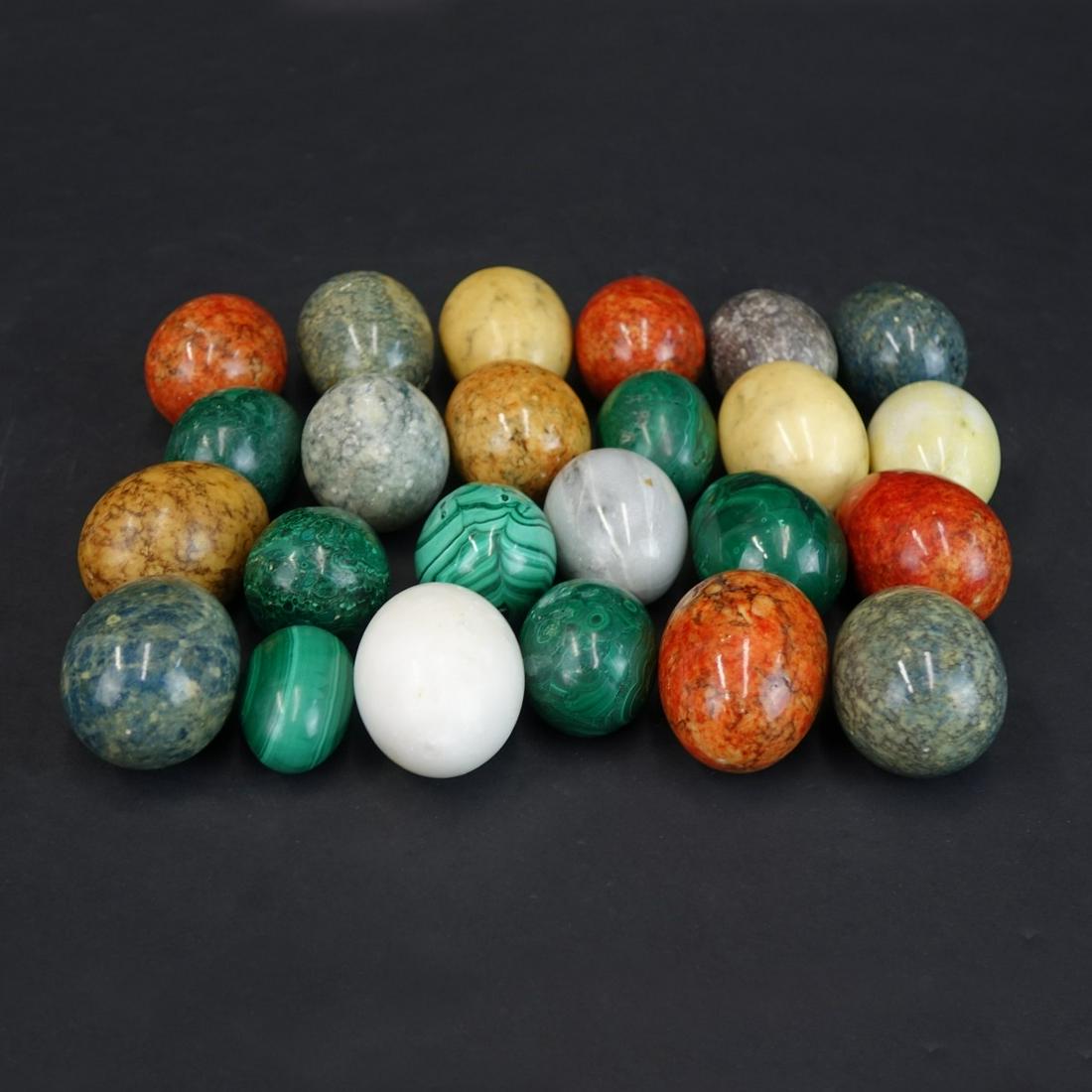 Semi Precious and Hardstone Eggs: Collection of Twenty Two (22) Semi Precious and Hardstone Eggs. Sizes range from 1-3/4" to. 2-1/2". Provenance: The estate of Leon Amar, Palm Beach, Florida. Condition: Good condition. Estimate: $50.0