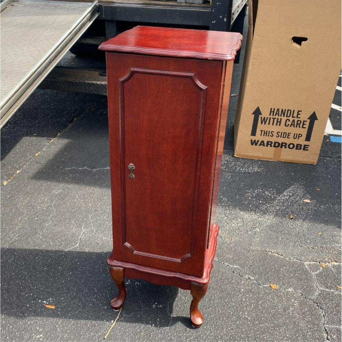 Powell Jewelry Armoire: Modern Powell Jewelry Armoire. Label attached en verso. Having swinging door, and interior drawers with lined interior. Measures 41" x 15-1/4" x 14-3/8". Condition: Stain on interior of one drawer, sc