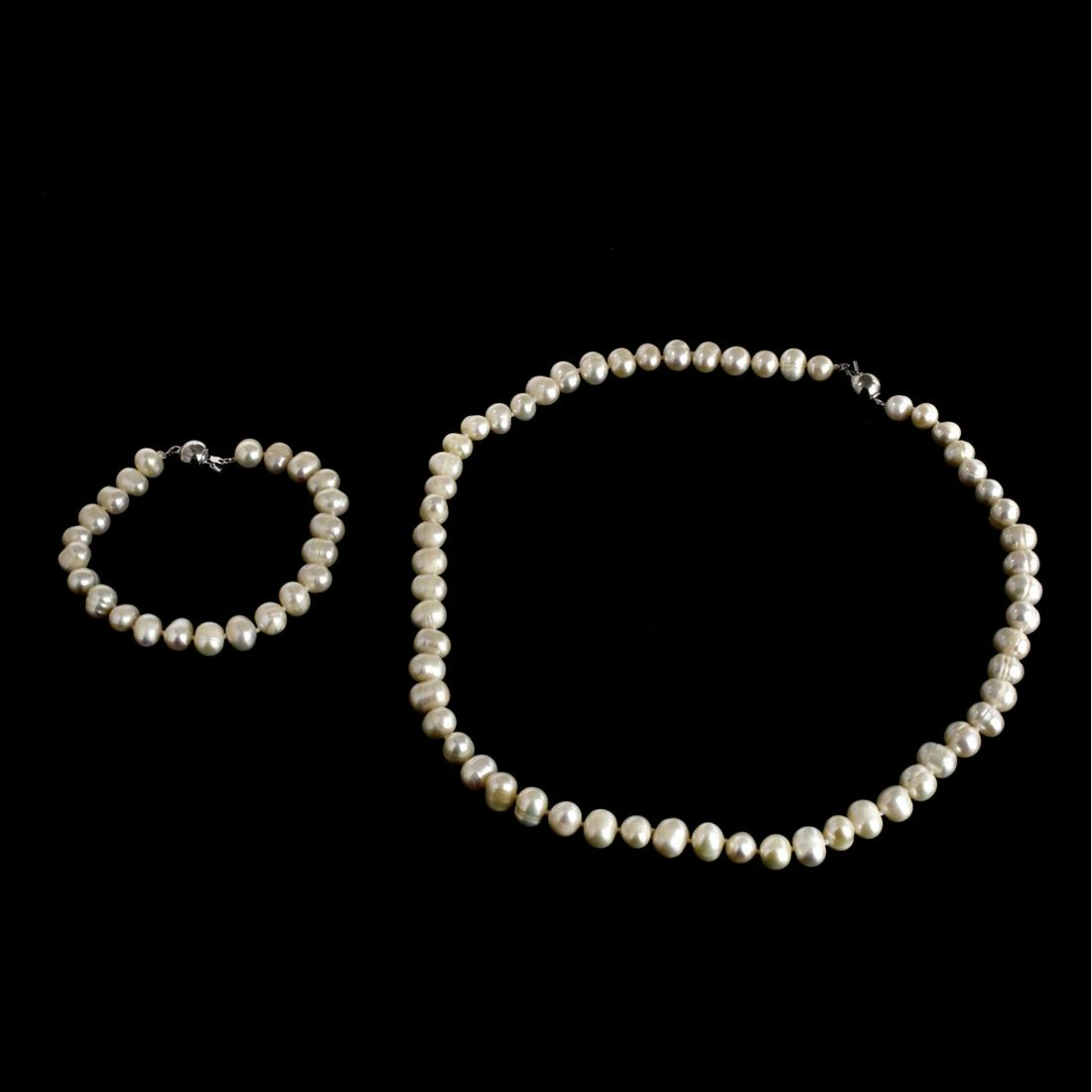 Vintage Pearl Necklace and Bracelet Suite: Vintage Approx. 9.5mm Baroque Pearl Beaded Necklace and Bracelet Suite. Necklace is stamped 18KPG. Necklace measures 17-1/2", bracelet measures 7-1/2". Condition: Good condition. Estimate: $50.00 - $1