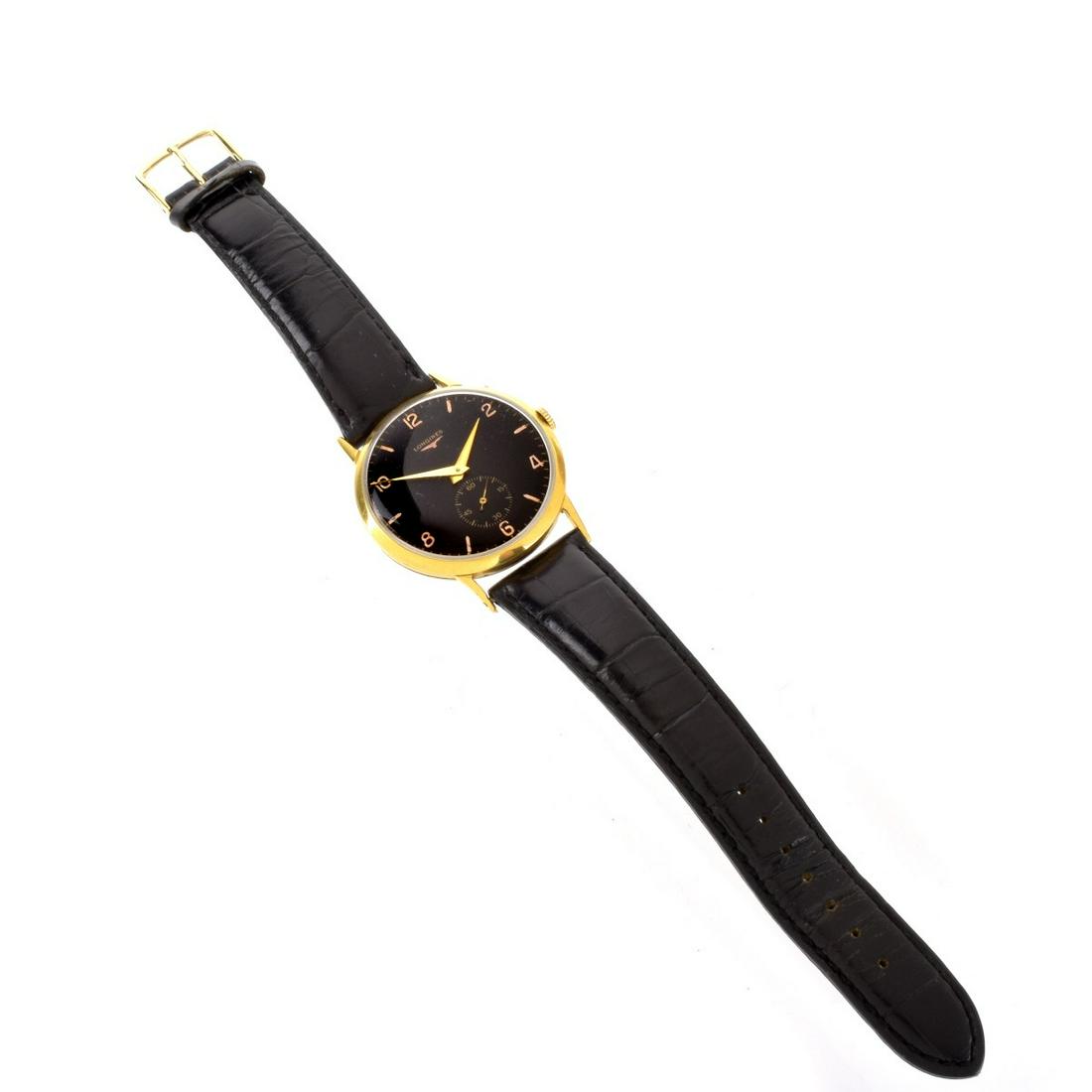 Longines Watch: Vintage Longines Two Tone Stainless Steel Watch with Leather Strap, Manual Wind Movement, Black Dial. Case measures 36.5mm. Strap measures 9" L. Condition: Good vintage condition. Running. Please note