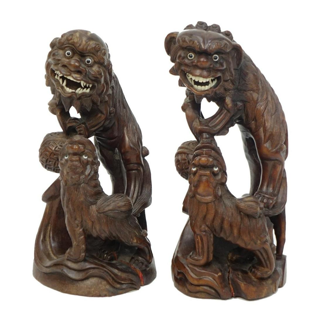 (2) Vintage Chinese Foo Dogs: Two (2) Vintage Chinese Hand Carved Foo Dog Groups with Bone Inlay and Glass Eyes. Measures 10-1/4" x 4-1/2". Condition: Seam split to one figure, rubbing otherwise good condition. Estimate: $50.00 - 