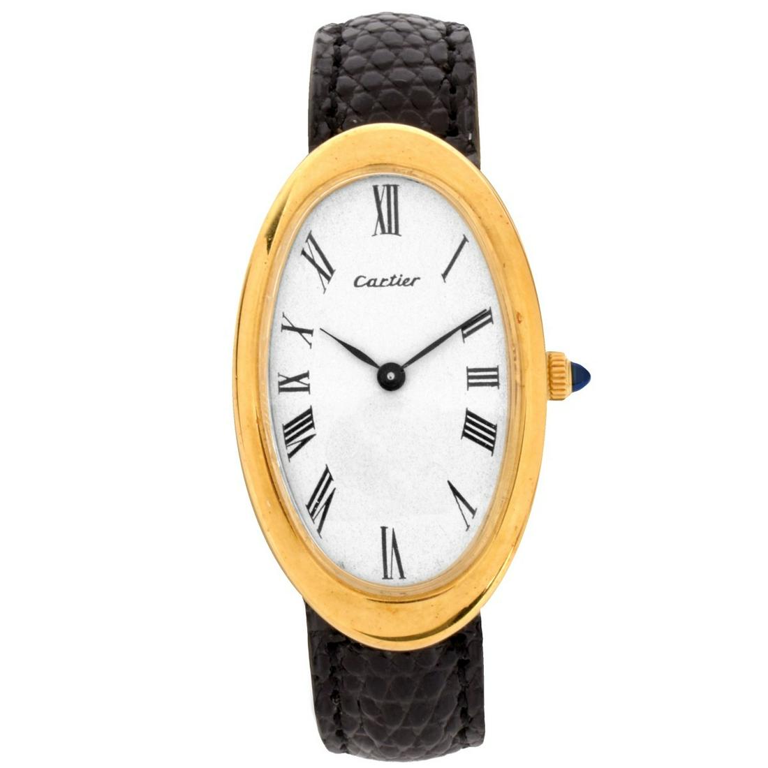 Cartier 18K Watch: Vintage Cartier 18 Karat Yellow Gold Oval Watch with Leather Strap, 18 Karat Yellow Gold Buckle. Manual wind movement. Case measures 40.5 x 24.0mm. Strap Measures 8" L. Approx. weight: 28.53 grams. Co