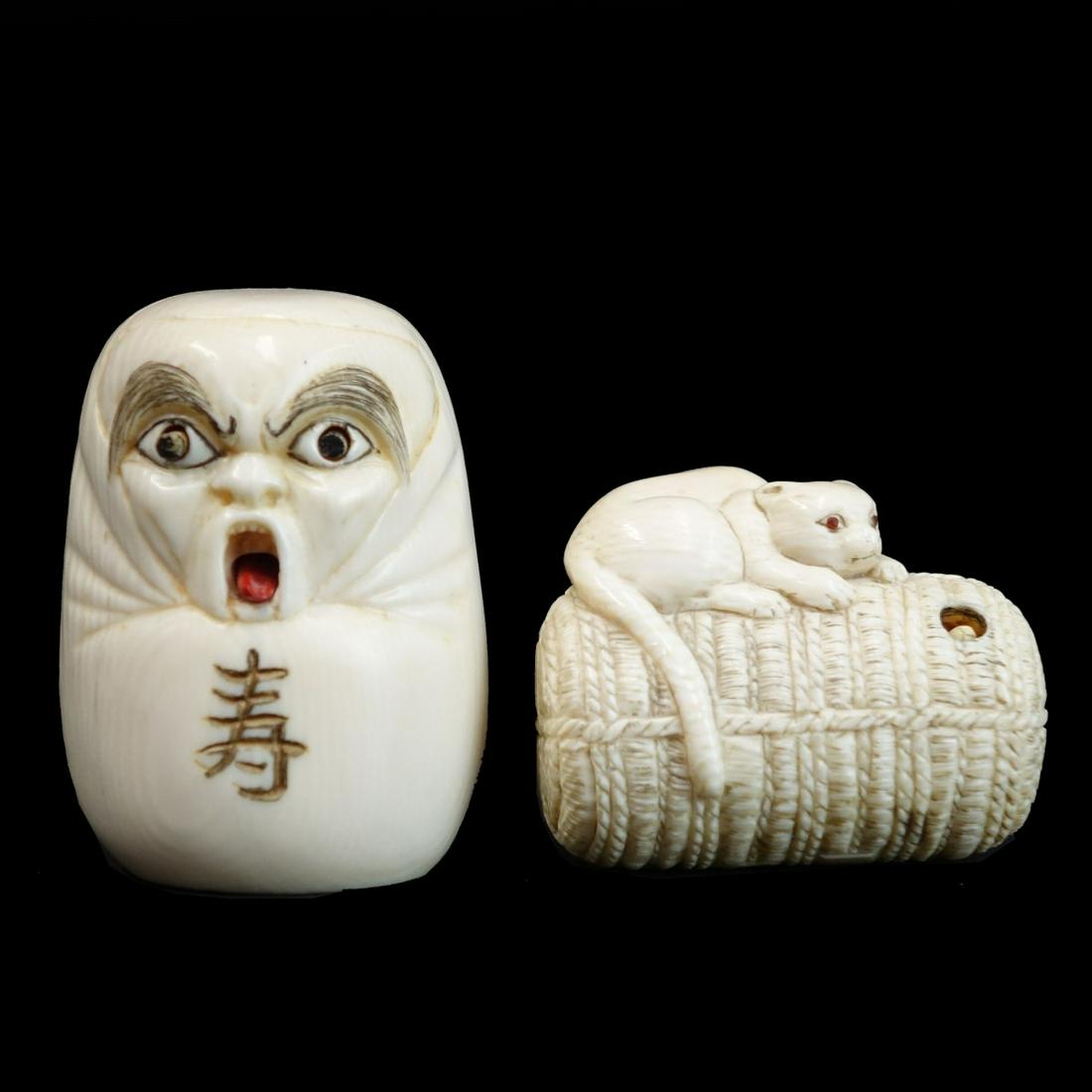 Japanese Netsukes: Grouping of Two (2) Antique Japanese Carved Netsukes. Signed. Lot consists of a mask figure with moving eyes and tongue together with Cat figure with moving mouse. Mask measures 2", other measures 1-1