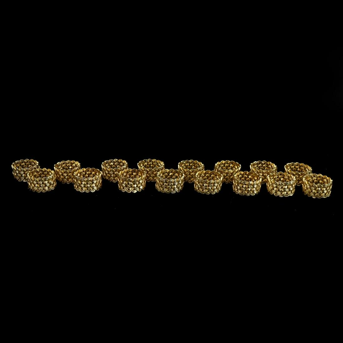 Napkin Rings: Lot of Sixteen (16) L,Object Gilt Metal Braided Napkin Rings. Measures 1-3/4" x 1". Condition: Good condition. Estimate: $100.00 - $300.00 Domestic Shipping: $58.00