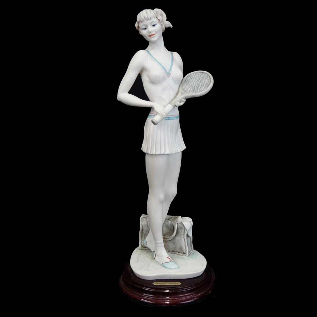 Giuseppe Armani Figure: Giuseppe Armani "Tennis Girl" Porcelain Figure. Signed and Dated on Reverse side. Overall measures 13-1/2". Condition: Small loss to the bag detail otherwise good condition. Estimate: $100.00 - $200.0