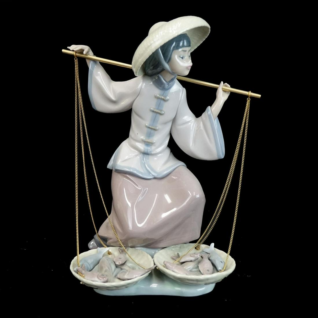 Lladro Figurine: Lladro "Fish a Plenty" Porcelain Figurine. Signed and numbered 5172. Measures 9-3/4" x 8" x 6". Condition: Good condition. Estimate: $100.00 - $200.00 Domestic Shipping: $72.00