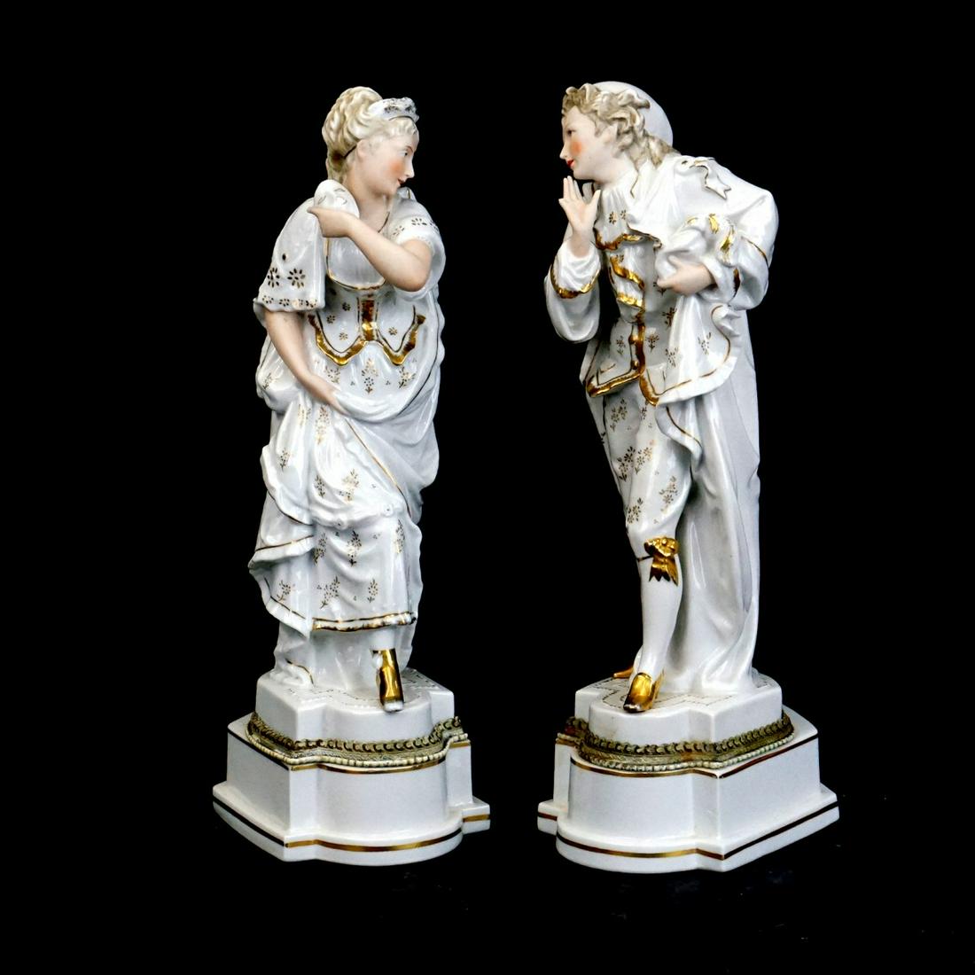 Antique Style Figurines: Pair of Antique Style Porcelain Figurines. Crossed arrows mark and label attached on the bottom side. Pair measures 14-5/8" x 4-1/4" x 6-1/4". Condition: Previously drilled as lamps, rubbing, male fig