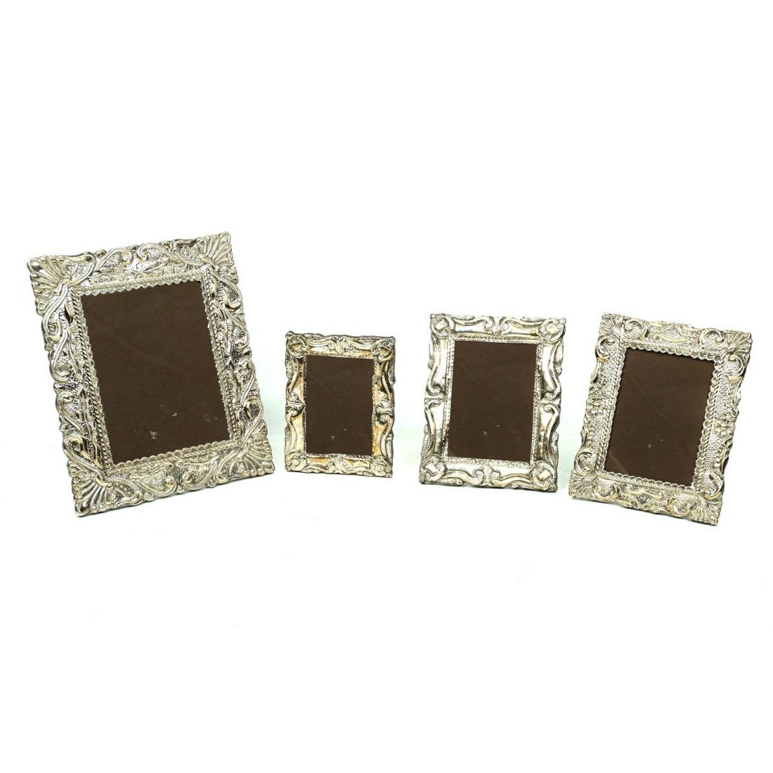Photo Frames: Lot of Four Silver Mounted Photo Frames. Unmarked. Each having a wooden backing. Largest sight measures 8-3/4" x 6-1/2". Largest frame measures 13-1/2" x 11". Smallest sight measures 5-1/2" x 3-5/8".