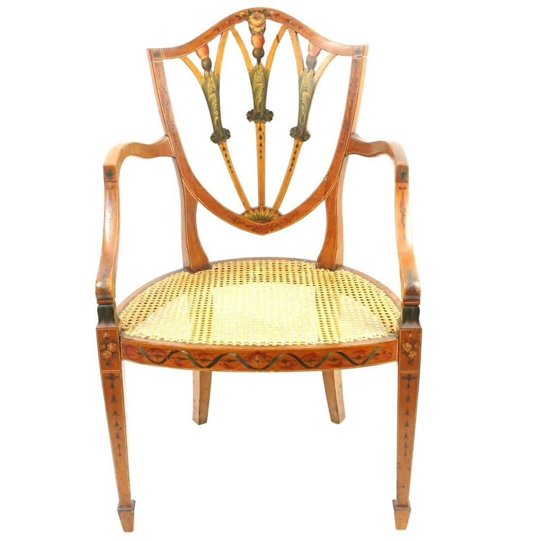 Adams Arm Chair: 19th Century English Hand painted Adams Arm Chair with Woven Cane Seat. Shield form back rest, painted detail on the apron and back rest, and stands on tapering legs. Measures 37" x 23" x 18-7/8". Con
