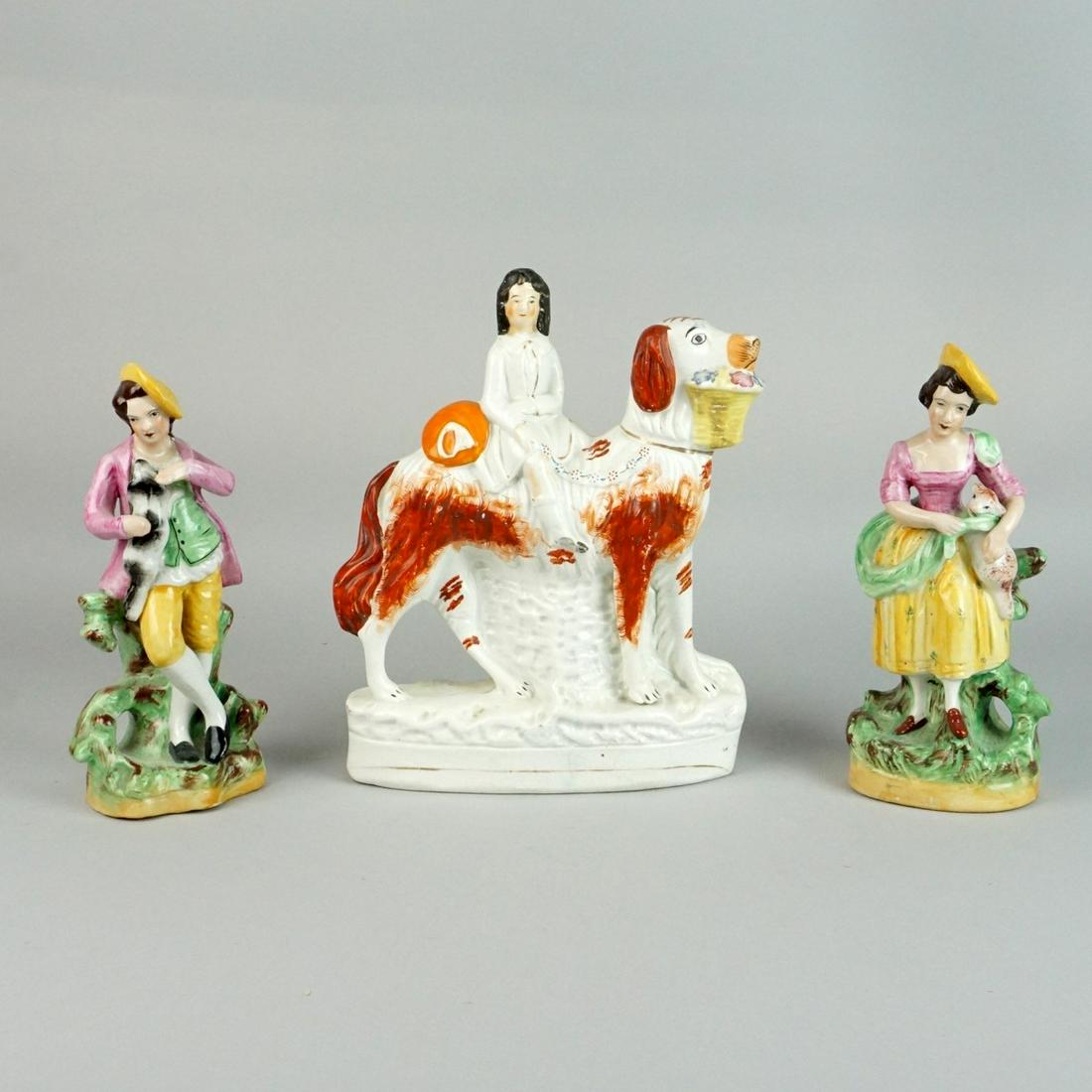 Staffordshire Figurines: Grouping of Three Staffordshire Pottery Figurines. Includes a pair of William Kent figurines together with a a royal child on dog figurine. William Kent figurines are signed on the base. Tallest measu