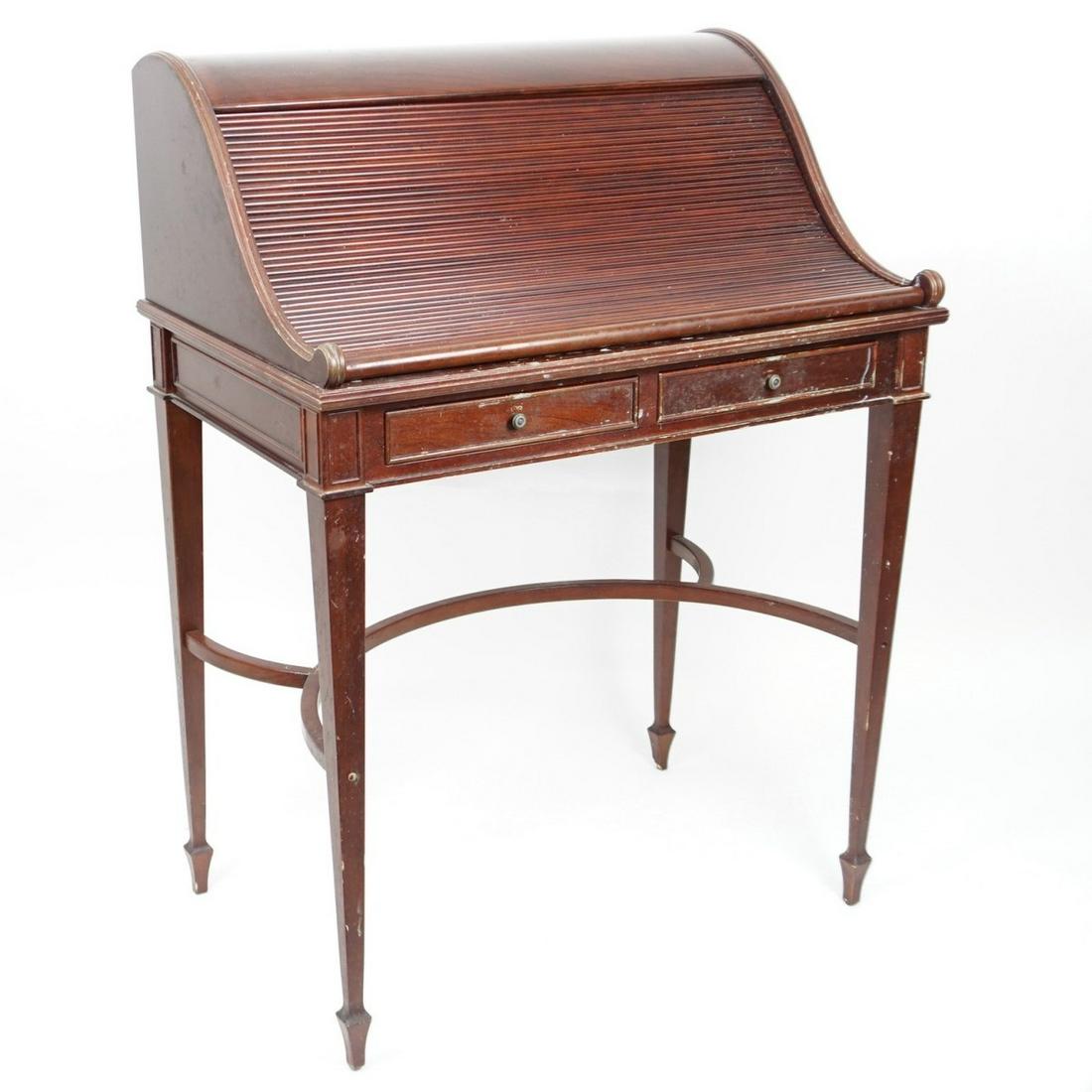 Writing Desk: Mid 20th Century Roll Top Writing Desk. Opens to a tolled leather writing surface with drawers, three sliding drawers on the apron, and stands on tapering legs. Measures 41" x 29-1/2" x 20". Condition