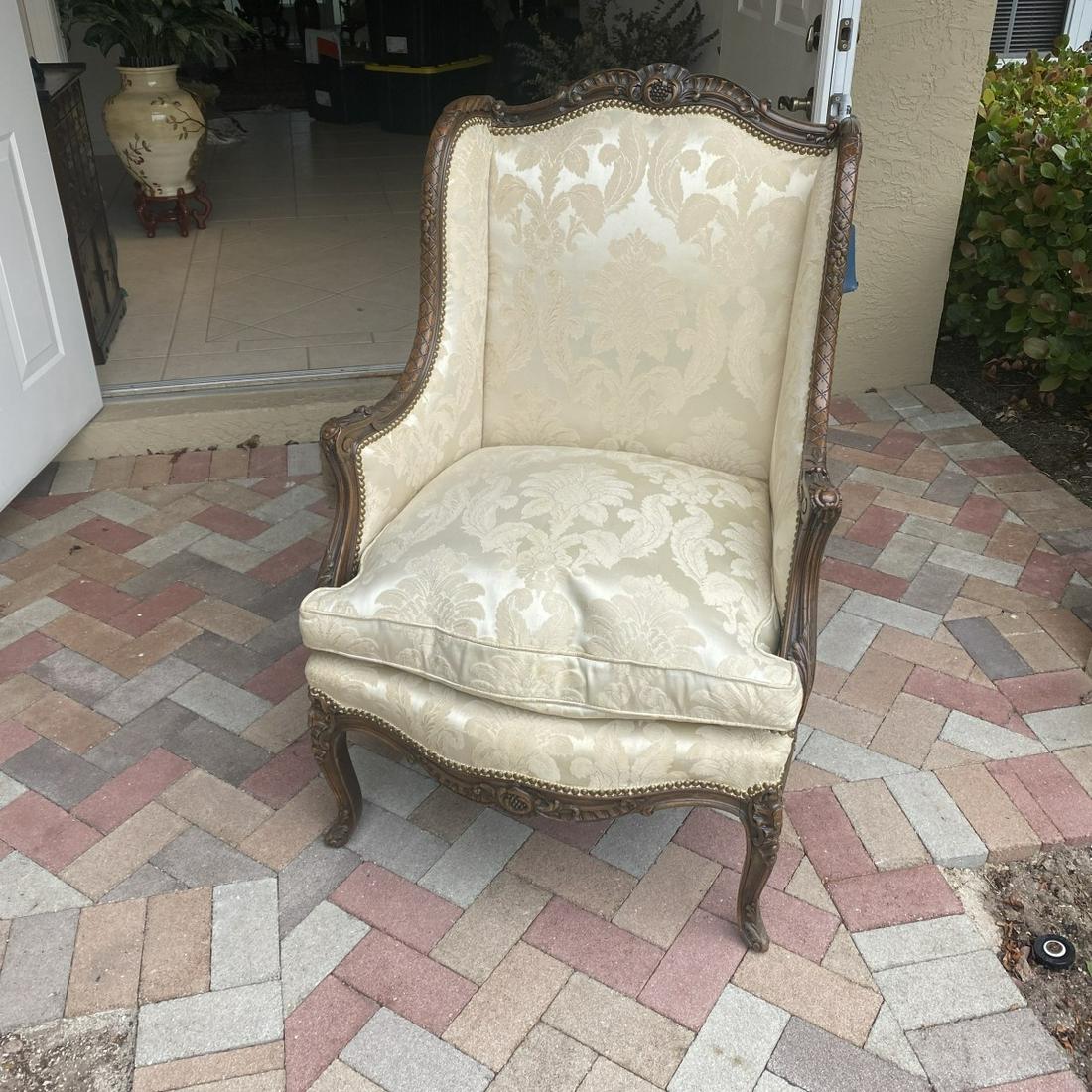 Bergere Chair: 20th Century French Louis XV Style Bergere Chair. Carved shell and scroll detail on the frame and stands on cabriole legs. Measures 44-1/2" x 29-3/4" x 31". Condition: Good condition. Estimate: $100.0