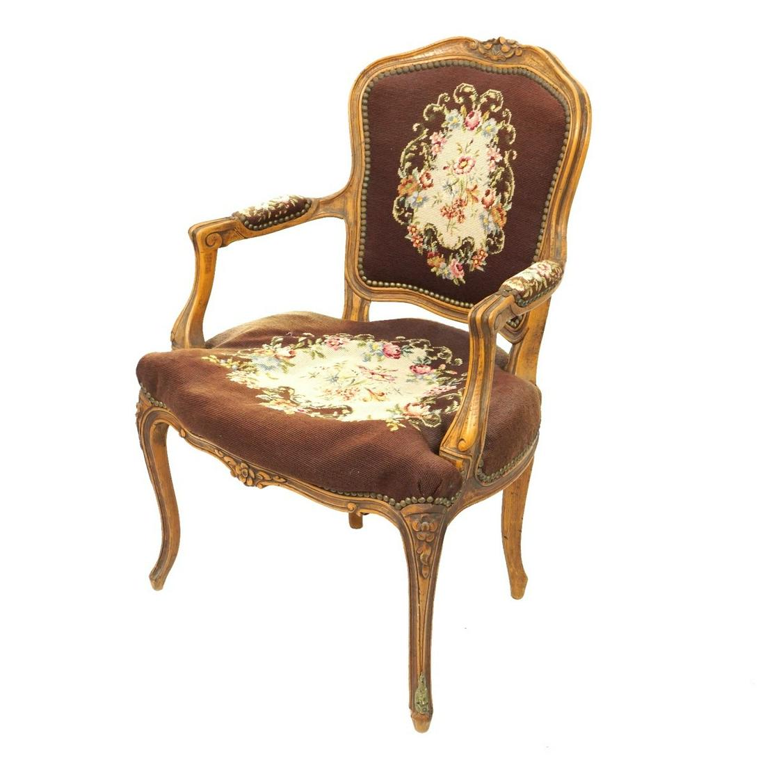 Louis XV Style Fauteuil: 20th Century Louis XV Style Carved Beechwood Needlepoint Fauteuil. Measures 34-1/2" x 24" x 20". Condition: Discoloration to the needlepoint work, interior cushion is stiff (needs to be re-filled othe