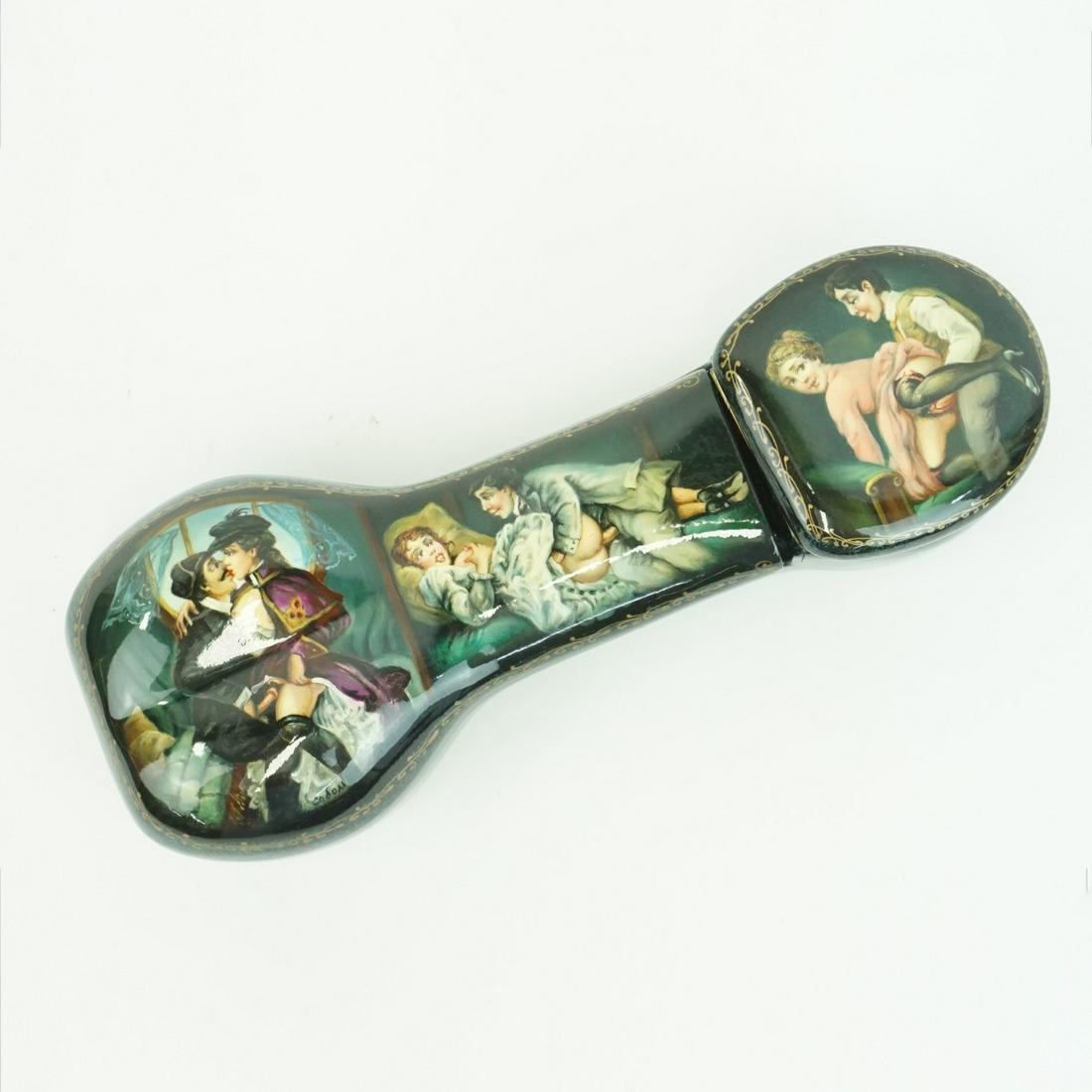 Russian Erotic Lacquer Box: Russian Erotic Painted and Parcel Gilt Lacquer Hinged Box. Phallus shape box with three erotic scenes, two hinged top compartments. Artist signed. Measures 7-1/8" x 2-5/8" x 1-3/4". Condition: Very go