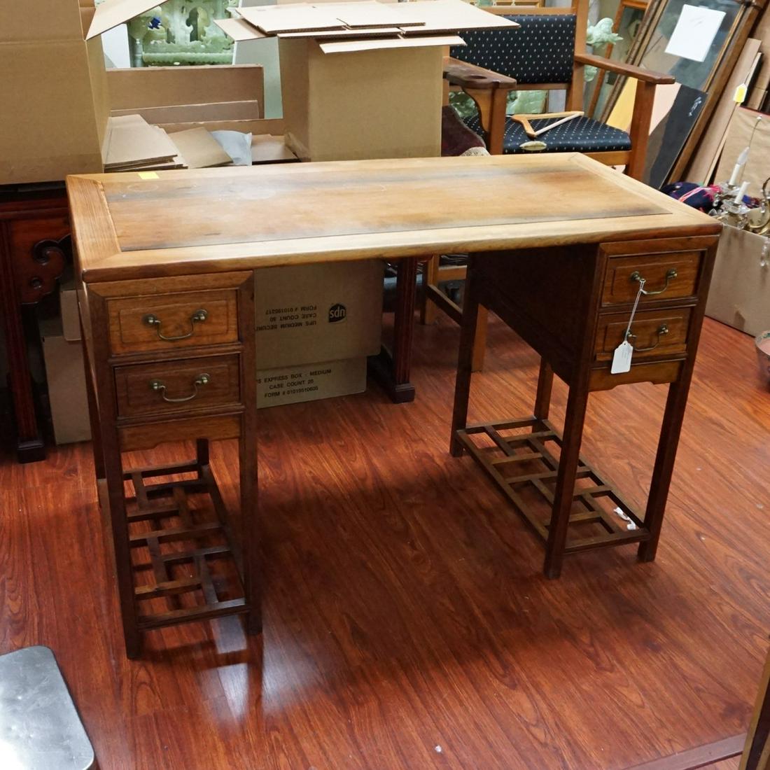 Chinese Pedestal Desk: Early 20th Century Chinese Hardwood Pedestal Desk. Features four sliding drawers, geometric bars supporting high tapering legs. Measures 33" x 49" x 23-1/2". Condition: Top has some cup stains and rub