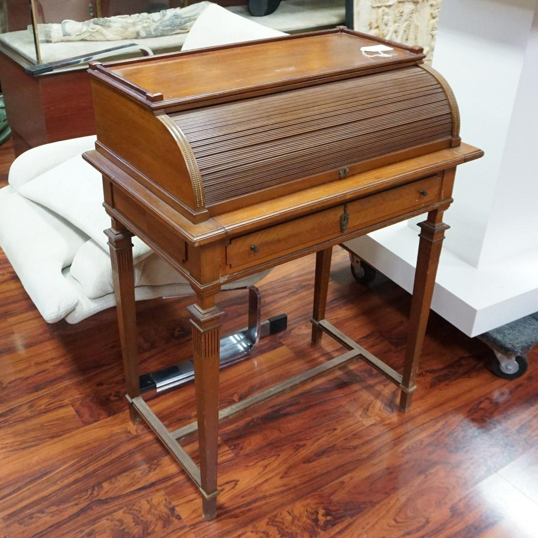 Writing Desk: Antique French Roll Top Writing Desk. Opens to a felt lined writing surface and storage compartments standing on tapering legs. Measures 36-3/4" x 28" x 17-3/4". Condition: Scratches and rubbing to th