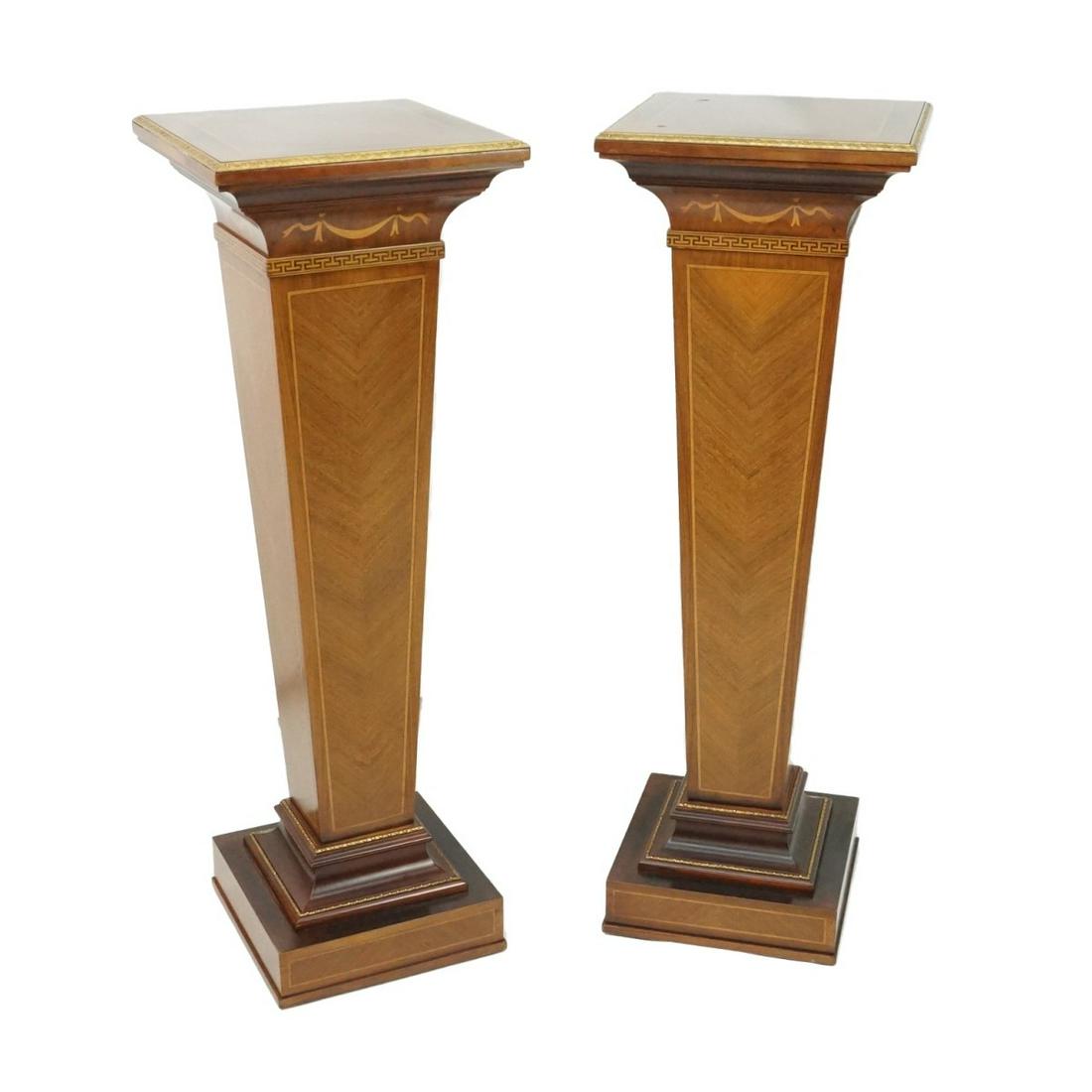 Pair of Pedestals: Pair of Neoclassical Style Inlaid Wooden Pedestals with Bronze Mounts. Key and ribbon motif. Measures 37-3/4" x 12-5/8". Condition: Fading to the top otherwise good condition. Estimate: $200.00 - $600