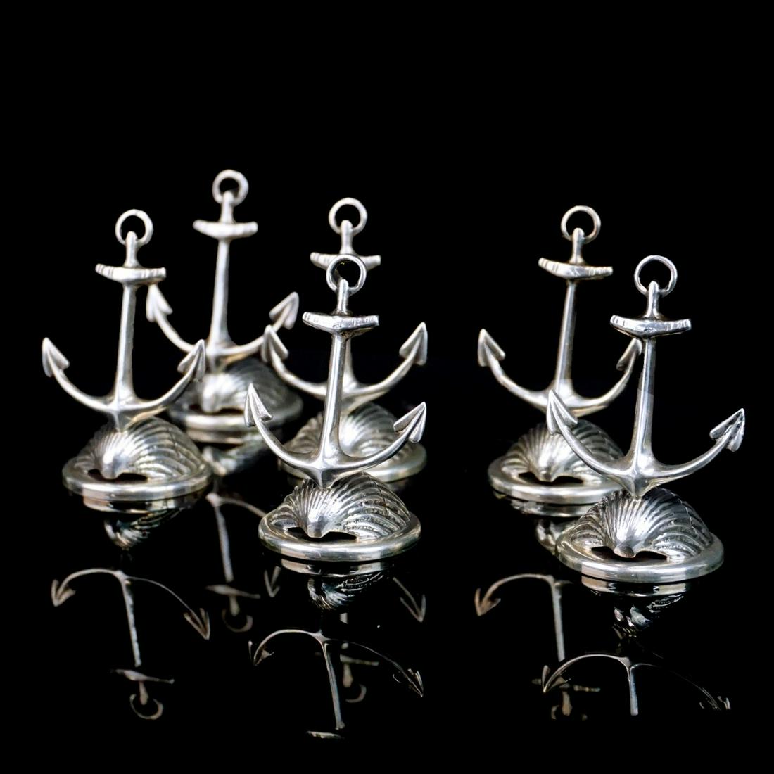 Place Card Holders: Set of Six Italian Sterling Silver Place Card Holders. Stamped 925 and marked with star 329 FL on the base. Measures 2" x 1-1/4". Approx. weight: 3.2 troy ounces. Condition: Good condition. Estimate: