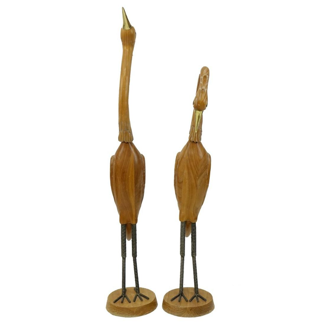 Carved Crane Sculptures: Two (2) Life Size Wood Mid Century Carved Crane Sculptures with Brass Detail. Tallest measures 61". Other measures 50-1/2". Condition: Some surface rubbing, scratches otherwise good condition. Estimat