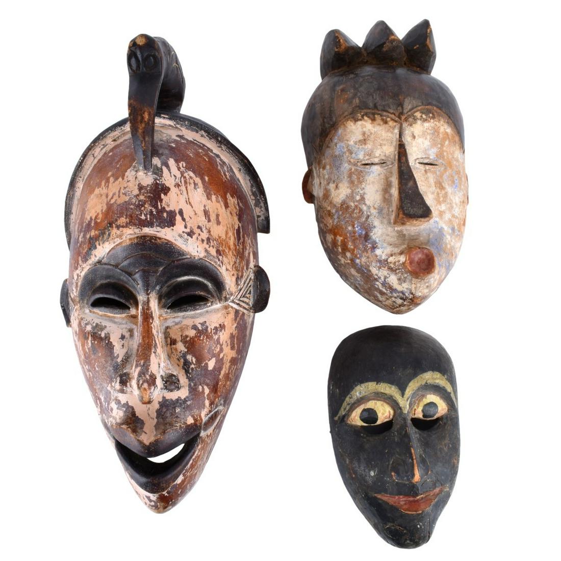 Three African Carved Masks: Grouping of Three (3) African Polychrome Wood Carved Masks. Various forms. Largest measures 19" H x 9" W, smallest measures 9" H x 5-3/8" W. Condition: Rubbing to paint and typical wear from age Estim