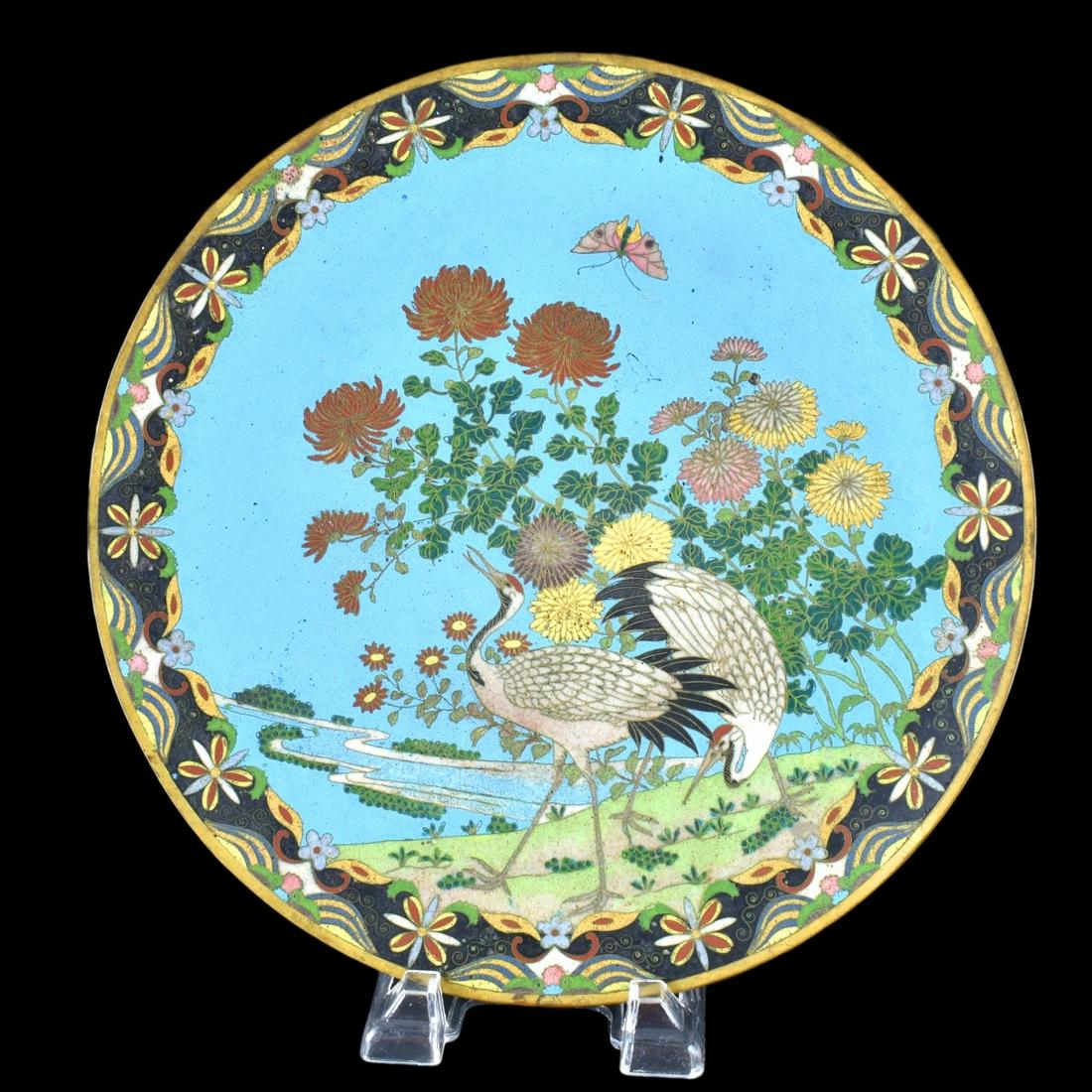 Japanese Cloisonne Enamel Charger: Large Japanese Cloisonne Enamel Charger. Decorated with cranes, flowers, and butterfly motif. Measures 12-1/4" Dia. Condition: Good condition Estimate: $50.00 - $250.00 Domestic Shipping: Third Party