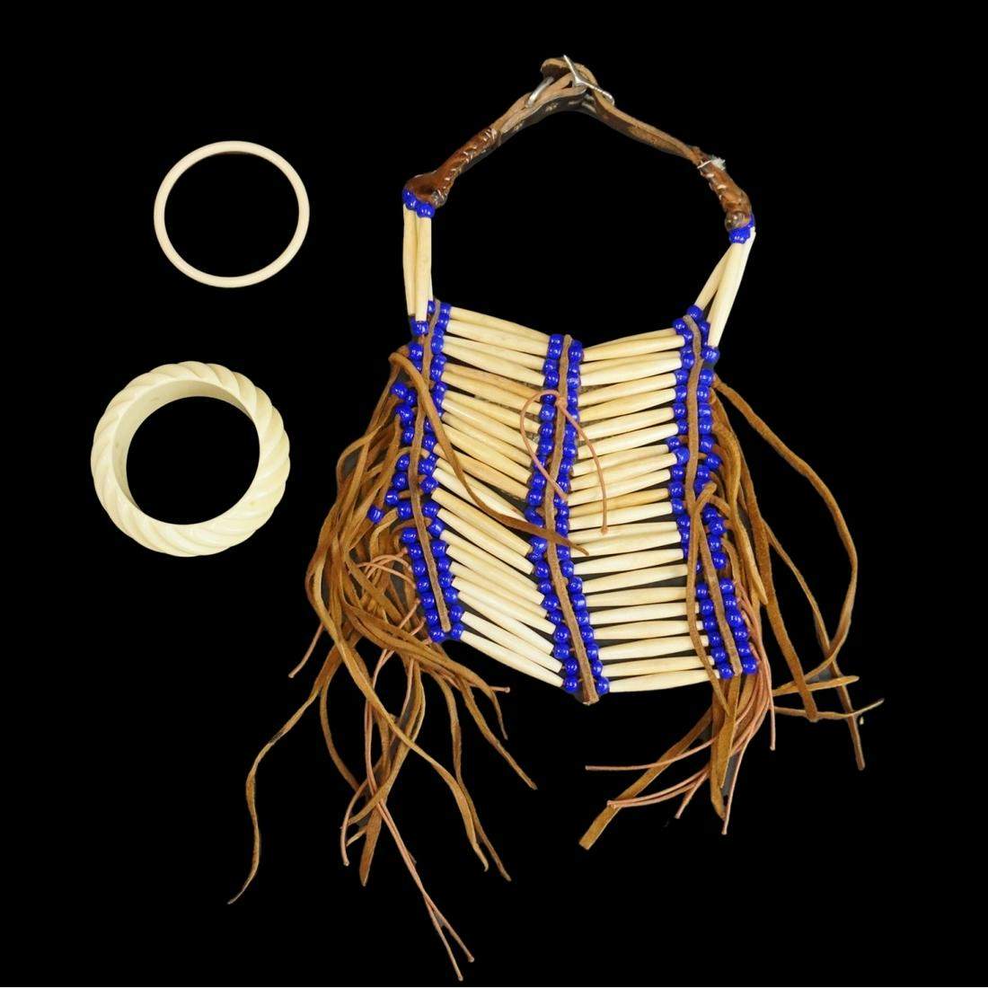 Choker and Two Bangle Bracelets: Vintage Native American Choker Necklace with Bone, Beaded, Leather, and Abalone Embellishments Together with Two Carved Bangle Bracelets. Choker is adjustable. Large bangle measures 1-1/4" x 2-3/4" (i