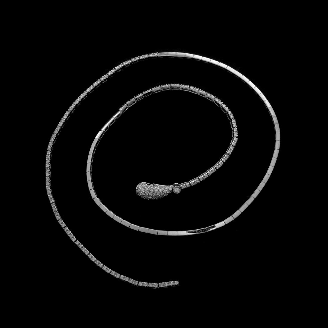 Diamond and 14K Necklace: Vintage Round Brilliant Cut Diamond and 14 Karat White Gold Snake Lariat Necklace. Diamonds G-H color, VS1-VS2 clarity. Stamped 14K. Measures 2-" L, 1/4" W (at head). Approx. weight: 17.73 grams. Cond