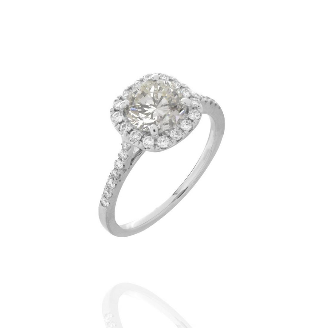 Diamond and 18K Ring: 1.22 Carat Round Brilliant Cut Diamond and 18 Karat White Gold Engagement Ring. Accented with approx. .50 carat TW round brilliant cut diamonds. Center diamond I color, VS1 clarity. Accent diamonds G-