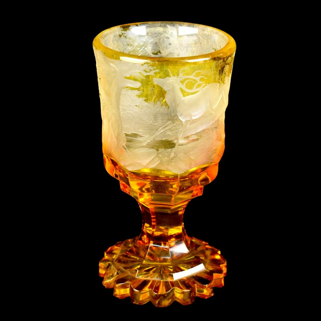 Antique Bohemian Chalice Vase: Antique Bohemian Amber Glass Chalice Vase. Etched landscape with deer scene. Measures 7-3/4" x 4-1/8". Condition: Chip to the base otherwise good condition. Estimate: $100.00 - $200.00 Domestic Shippi