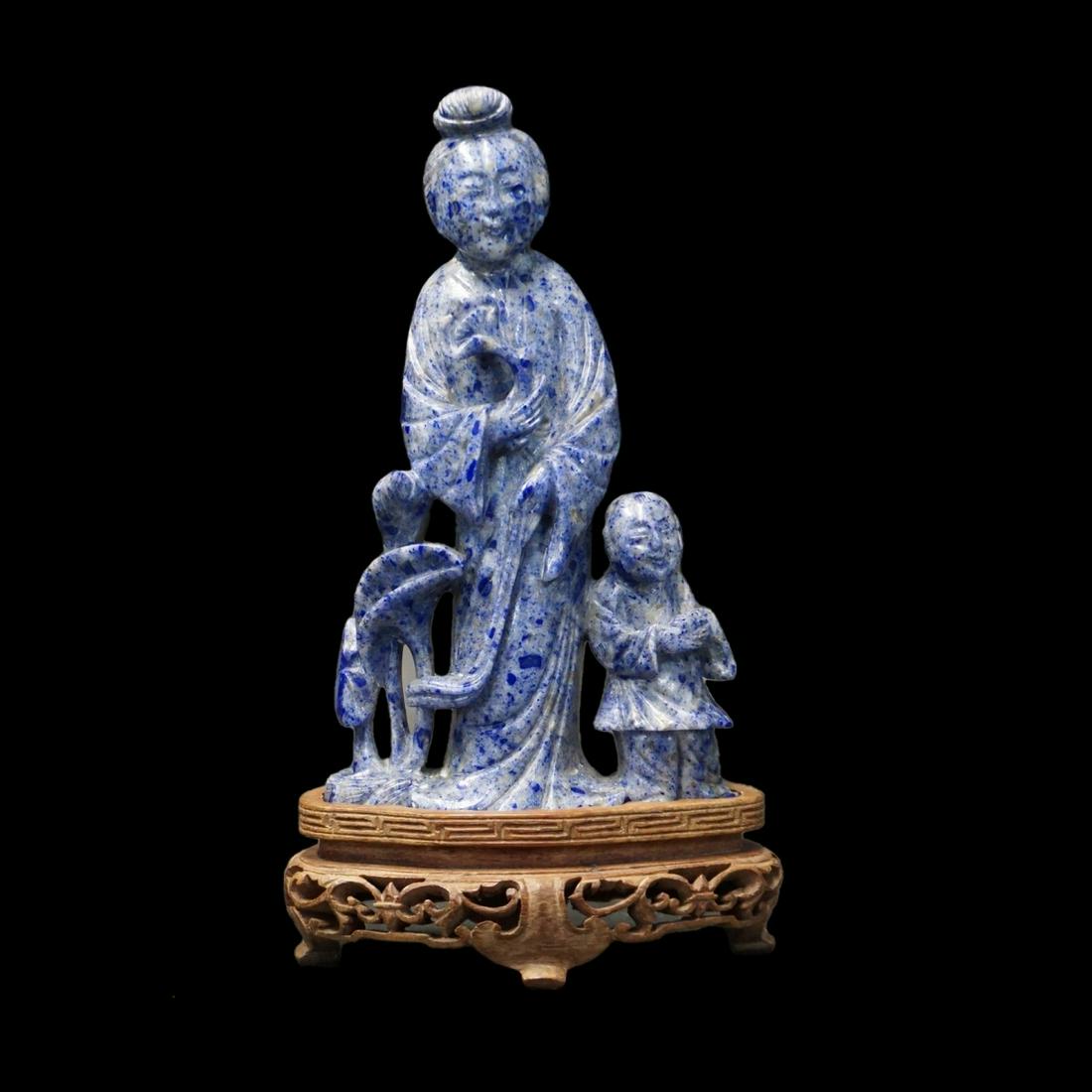 Chinese Figurine: 20th Century Chinese Carved Lapis Lazuli Guanyin and Child Figurine Presented on a Wooden Base. Figurine measures 5-3/4" x 3-1/4" (w/o base). Condition: Good condition.. Estimate: $200.00 - $300.00 Do