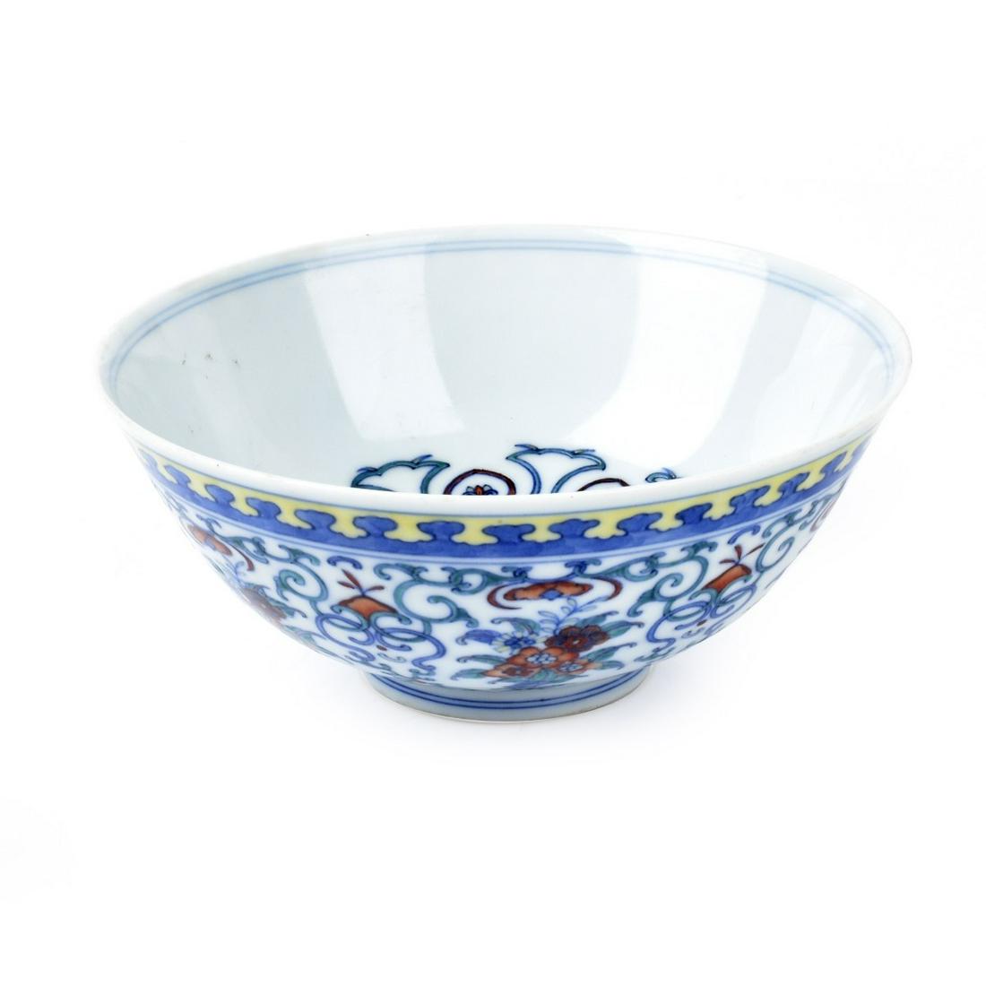 Chinese Doucai Porcelain Bowl: Chinese Doucai Porcelain Bow. All over scrolling vine design with flowers. Douguang (1821-1850) seal mark to base. Measures 2-7/16" H, 5-1/2" W (at rim). Estimate: $500.00 - $1000.00 Domestic Shipping