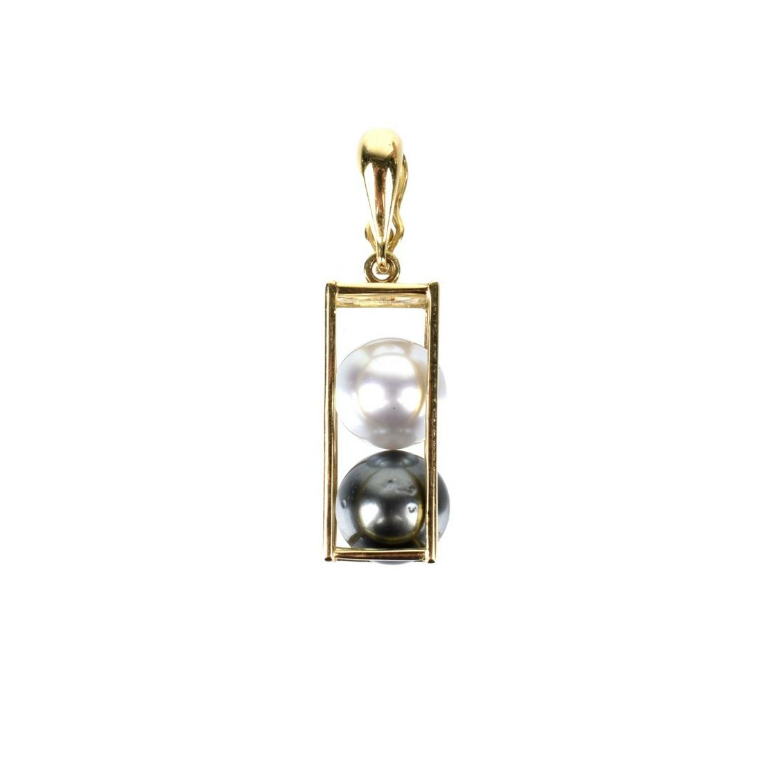 Tahitian Pearl and 14K Pendant: Vintage Tahitian Black and White 9mm Pearl and 14 Karat Yellow Gold Pendant. Pearls with good luster and polish, minor natural imperfections. Pendant measures 1-5/16" L, 3/8" W. Approx. weight: 3.1 dw