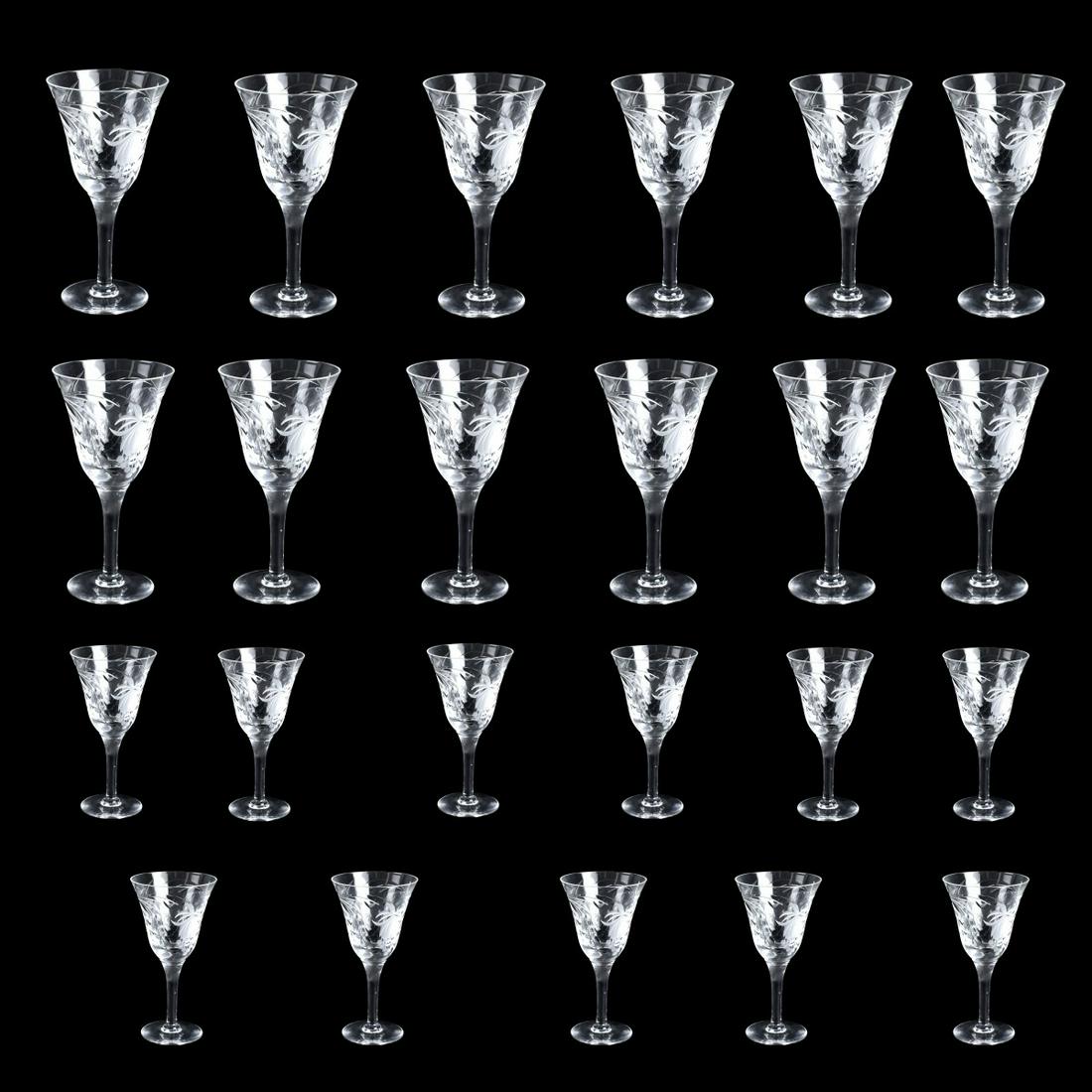 Royal Brierley "Fuchsia" Stemware: Lot of Twenty Three Royal Brierley "Fuchsia" Cut Crystal Stemware. Lot includes: (12) water goblets along with (11) claret wines. Signed. Goblets measure 7-1/2" H x 3-7/8" dia top. Wine glasses measur