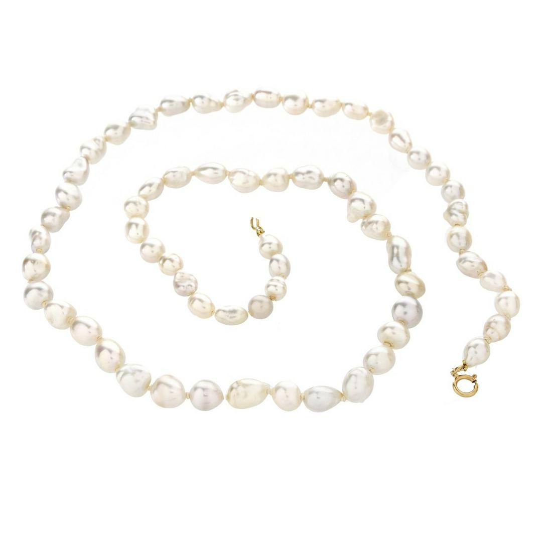 Pearl and 18K Necklace: Vintage Graduated Baroque Pearl Necklace with 18 Karat Yellow Gold Clasp. Pearls measure approx. 5.5-7.0mm. Necklace measures 20" L. Approx. weight: 15.8 dwt. Estimate: $50.00 - $150.00 Domestic Shipp