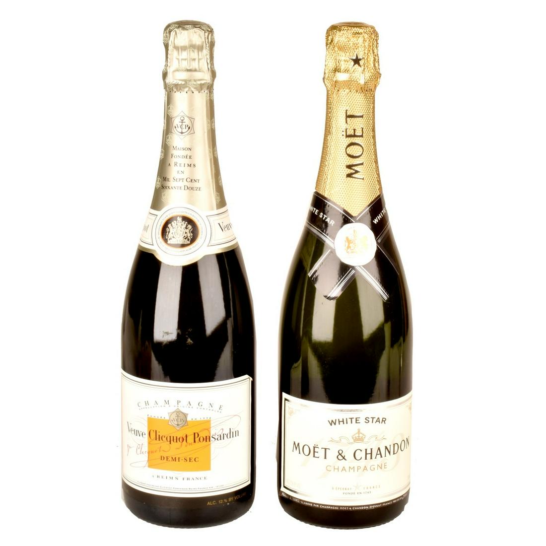 Two Art Glass Bottles of Champagne: Grouping of Two Art Glass Bottles of Champagne to Include Veuve Clicquot Ponsardin Demi Sec and White Star Moet & Chandon. Size: 750ml. Estimate: $100.00 - $200.00 Domestic Shipping: $58.00 Condition: