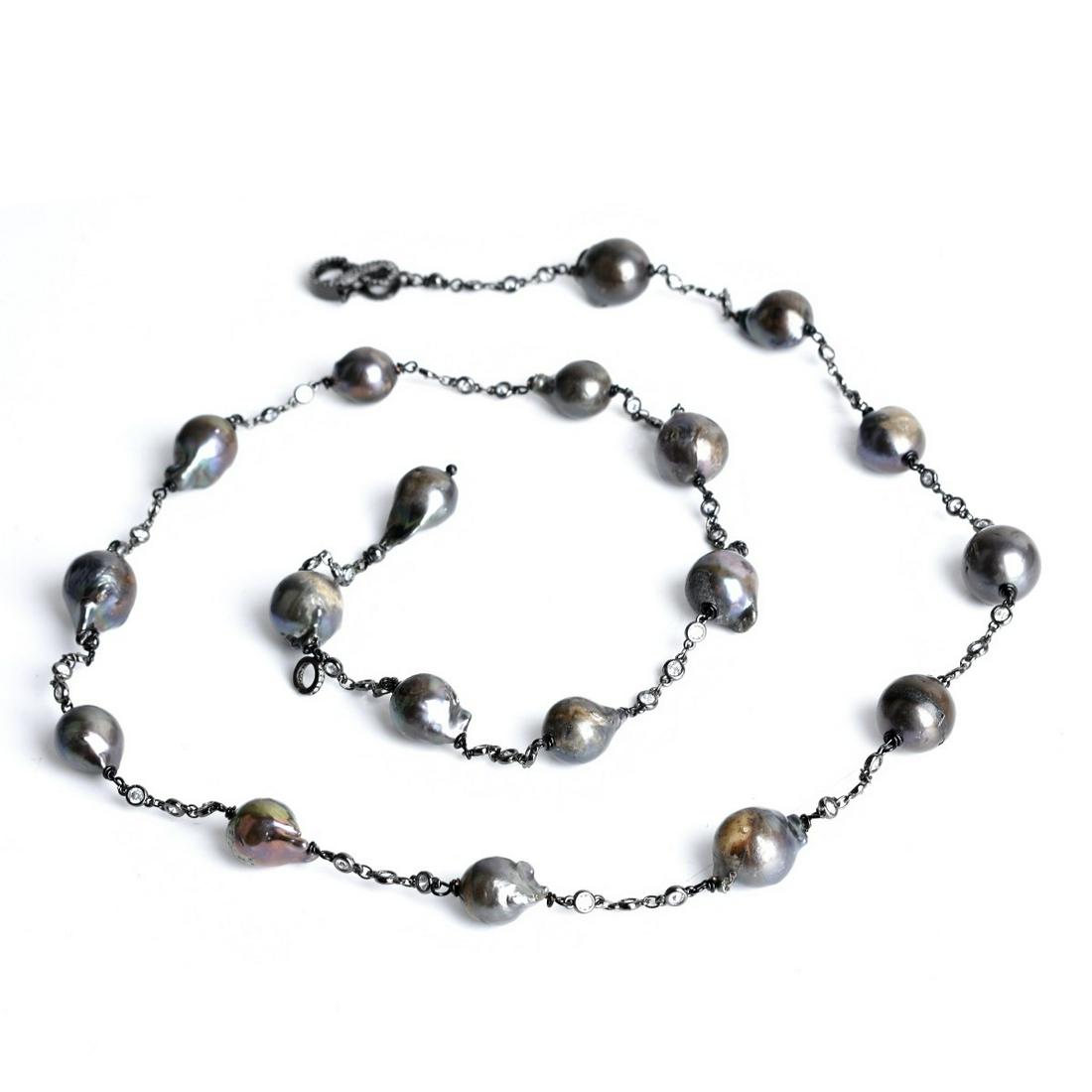 Baroque Pearl Necklace: Single Strand 13.0-15.0mm Black Baroque Pearl, Cubic Zirconia and Blackened White Metal Necklace. Measures 34" L. Approx. weight: 97.45 grams. Estimate: $50.00 - $150.00 Domestic Shipping: $40.00 Cond