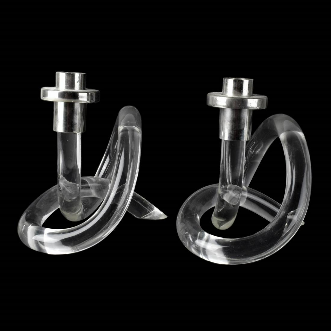 Pair of Dorothy Thorpe Style Candlesticks: Pair of Dorothy Thorpe Style Lucite and Chrome Candlesticks. Measures 7-1/4" x 8-1/4" x 6-1/2". Estimate: $50.00 - $100.00 Domestic Shipping: $82.00 Condition: Scuffs to the surface and a small chip t
