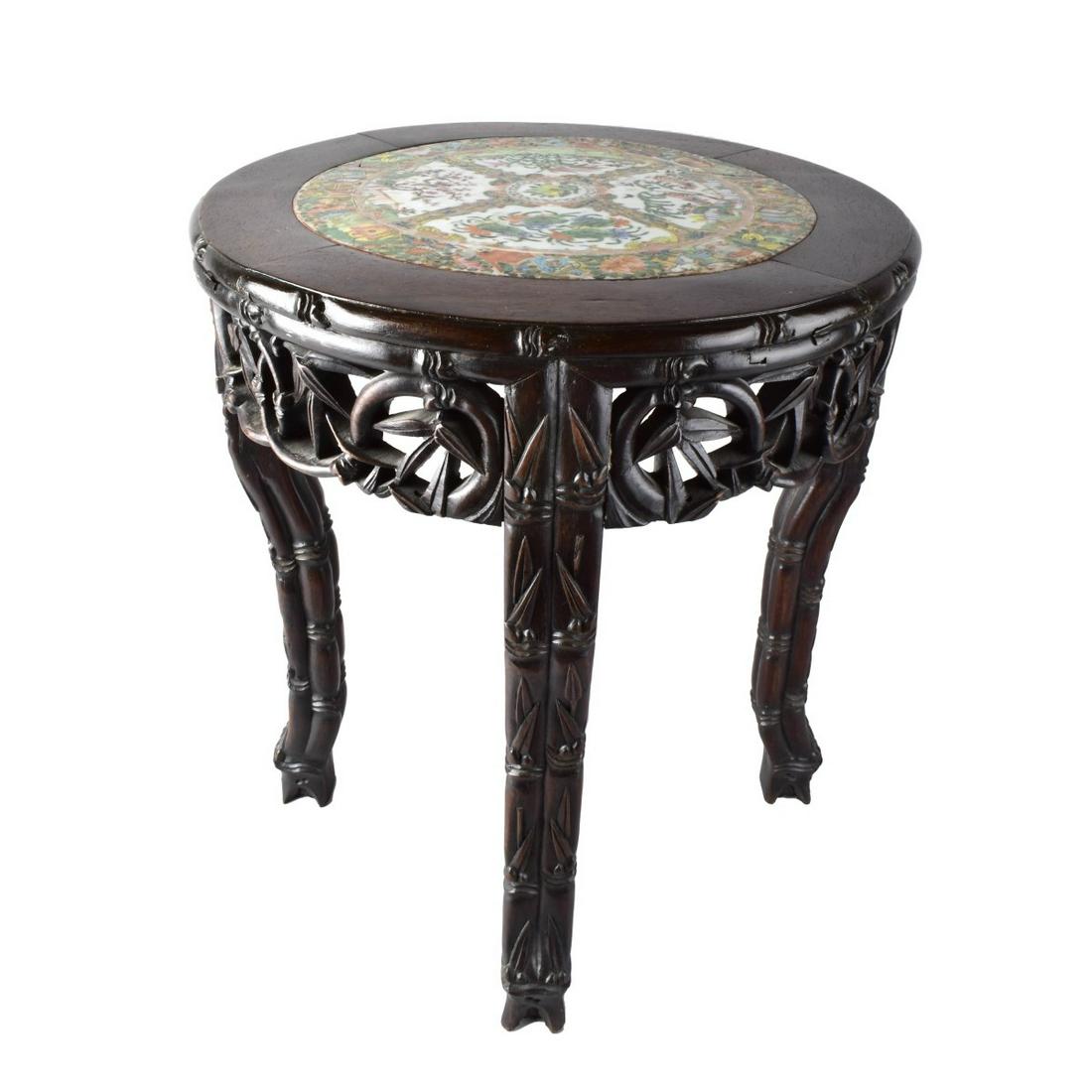Chinese Carved Pedestal Table: Chinese Carved Wooden Pedestal Table with Antique Rose Medallion Porcelain Top. Measures 18-1/2" x 16". Estimate: $50.00 - $100.00 Domestic Shipping: Third party Condition: As is condition.