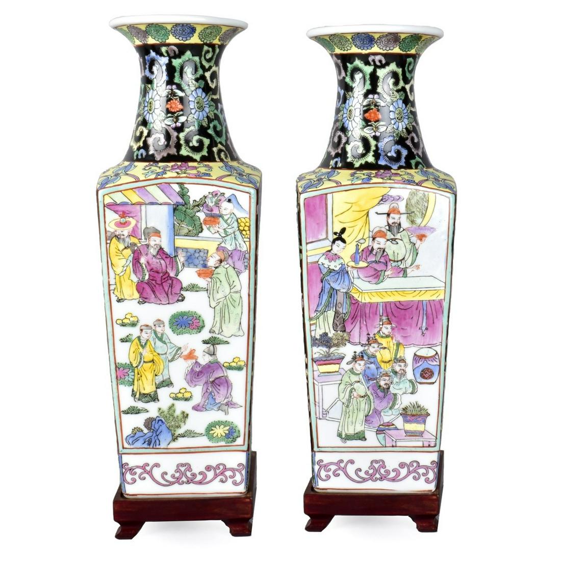 Pair of Chinese Famille Noir Vases: Pair of Chinese Famille Noir Porcelain Vases Presented on Wooden Bases. Signed. Vase measures 14-1/2" x 4-5/8". Estimate: $150.00 - $250.00 Domestic Shipping: Third party Condition: Good condition.