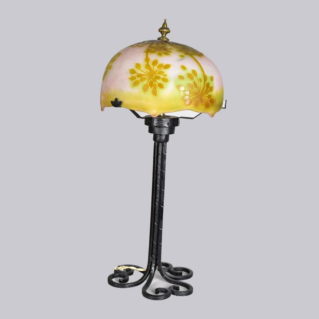 Galle Cameo Glass Lamp: Galle Art Nouveau Cameo Glass Lamp Presented on a Associated Iron Base, Signed on the shade. measures 6" x 10-1/2" (w/o finial). Overall height: 23-1/4". Estimate: $400.00 - $600.00 Domestic Shipping: