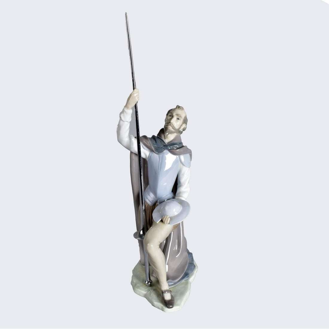 Lladro "The Quest" Figurine: Lladro "The Quest" (Don Quixote) Glazed Porcelain Figurine. Signed and numbered 5224 on the base. Figurine measures 10" x 8" x 4" (w/o staff). Condition: Some glue residue on the base of the staff. Es