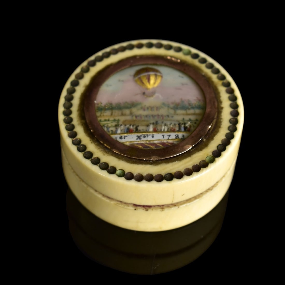 18th C. World's Fair Pill Box: 18th Century 1783 World's Fair Pill Box with 14 Karat Yellow Gold Inset Bezel Ring. Hand painted enamel scene of the Montgolfier balloon flight with inscription below. Measures 7/8" x 1-5/8". We Will